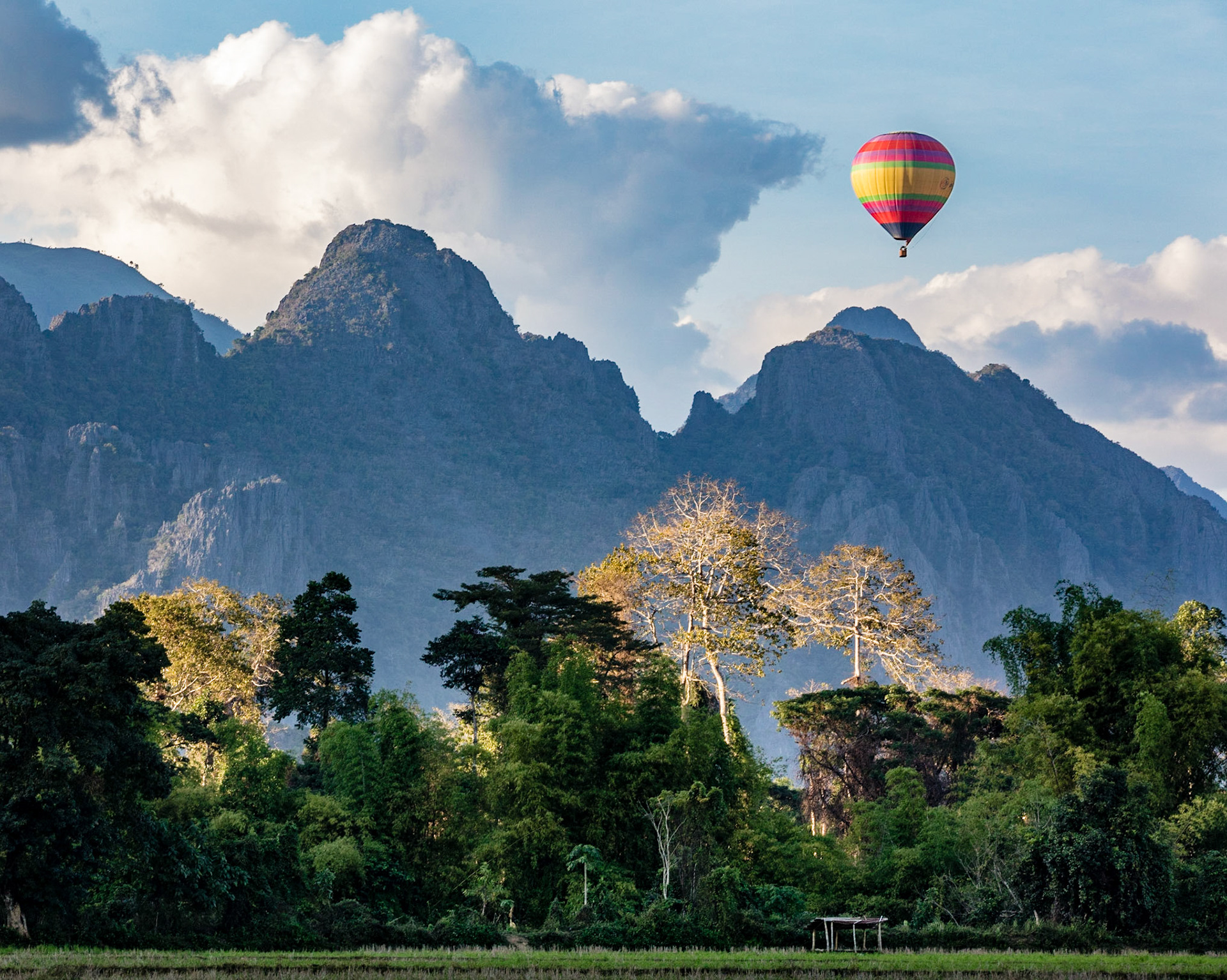 Looking up at a hot air balloon floating over the valley near Vang Vieng, Laos.