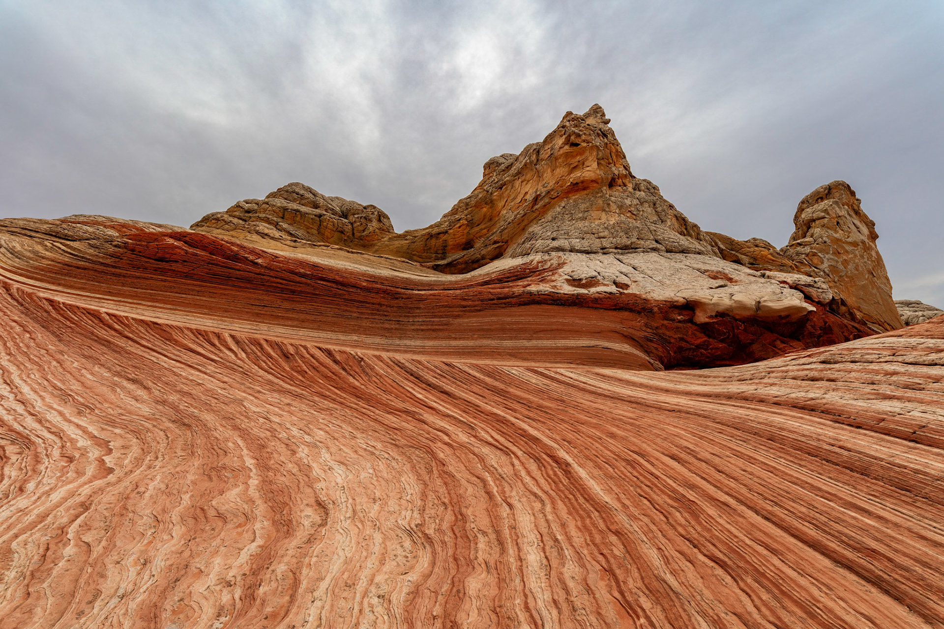 Red and White lines of sandstone going multiple directions around the rock formation called The Citadel in White Pocket, Arizona, USA.