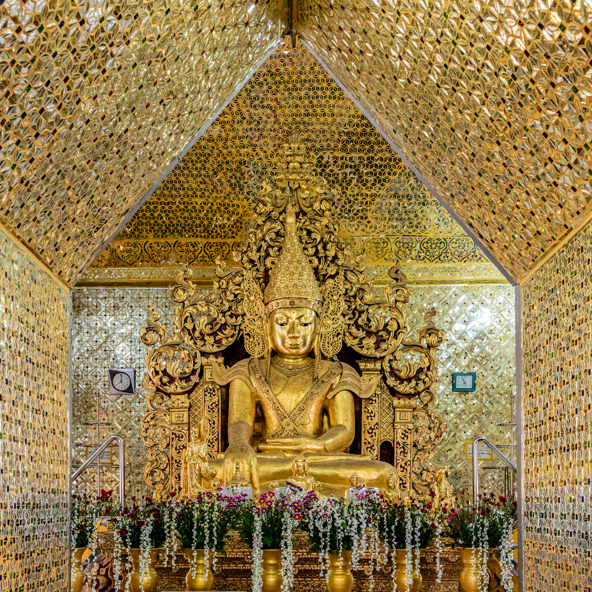 Golden Buddha surrounded by a room with walls covered in Gold in the Sandamuni Pagoda in Mandalay, Myanmar.