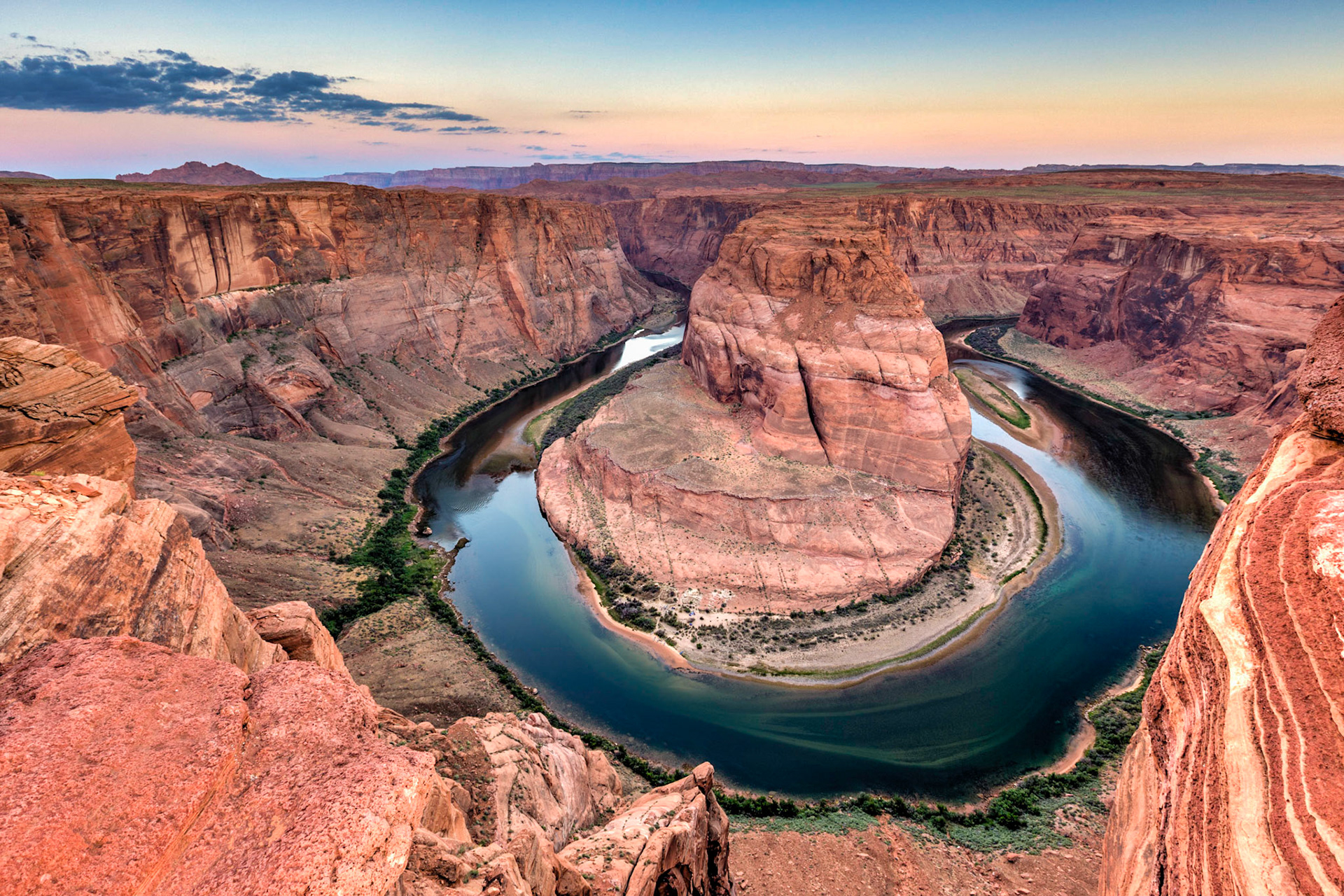 Early morning at Horseshoe Bend in Arizona show the geology of canyon as the shadow of the earth fades as the sun rises