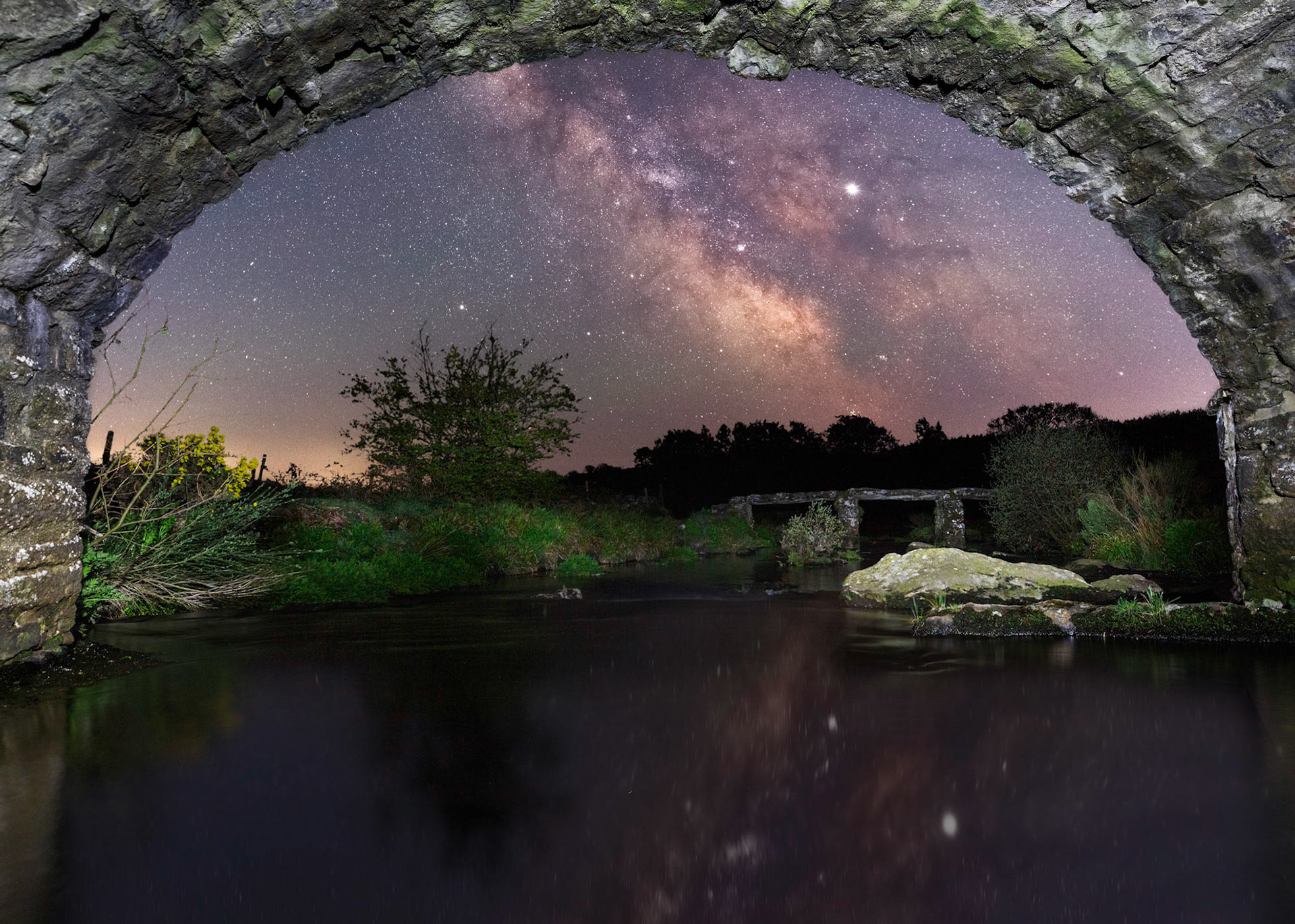 Under the road bridge at Postbridge with the Milky Way illuminating the sky.