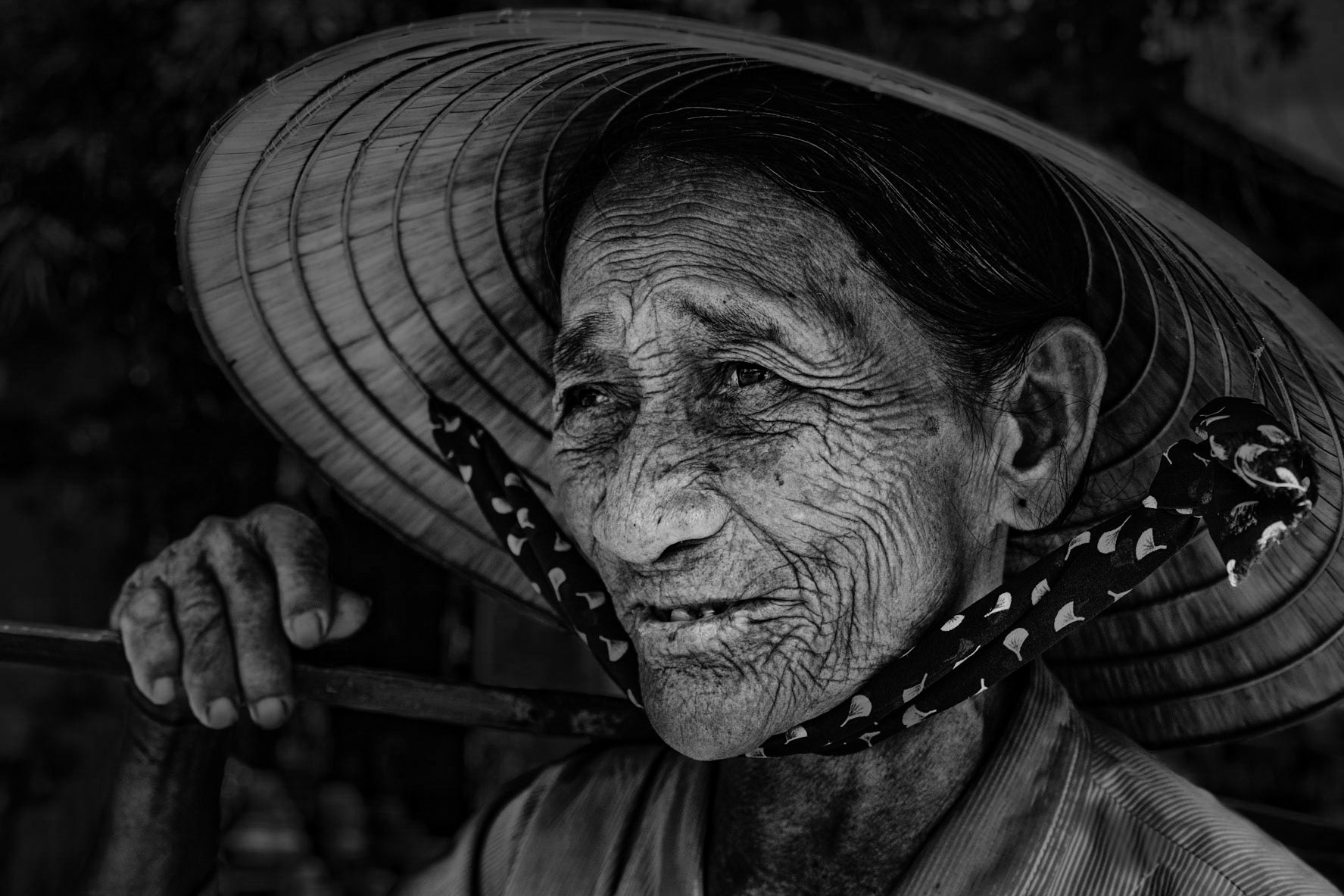 Portrait of an elderly woman who was selling bananas in Hoi An stopping for picture.