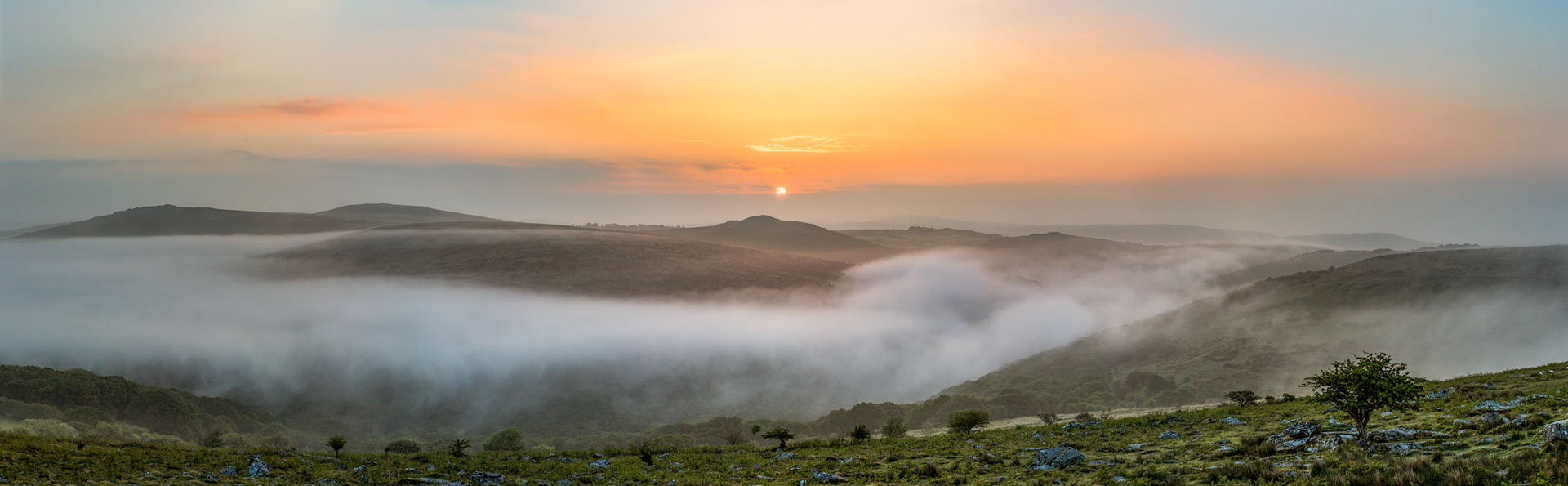 Above the Dart Valley at sunrise in Dartmoor National Park near Combestone Tor