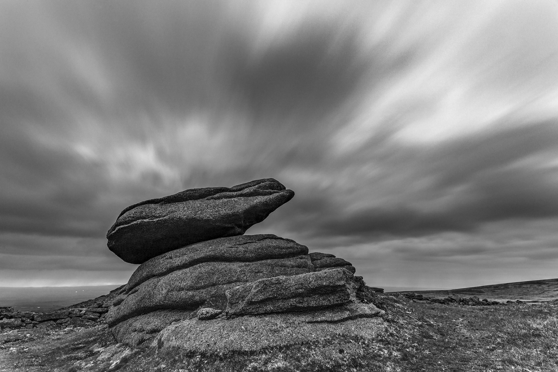 A cold dark and windy morning near Belstone tor as the clouds move quickly over the logan stone near Belstone tor.