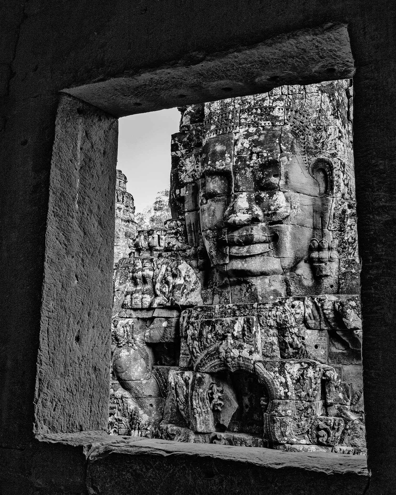 One of the Bayon temple faces framed in a temple window