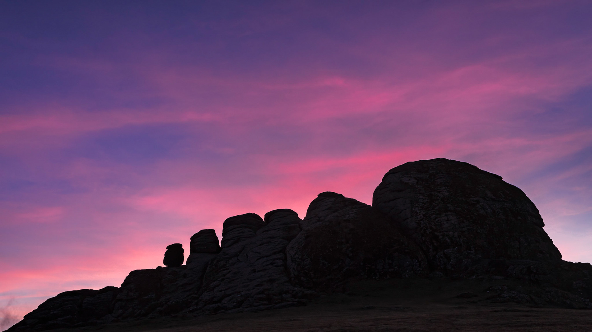 Haytor's sillouette to the pink clouds still illuminated by the sun that dipped below the horizon.