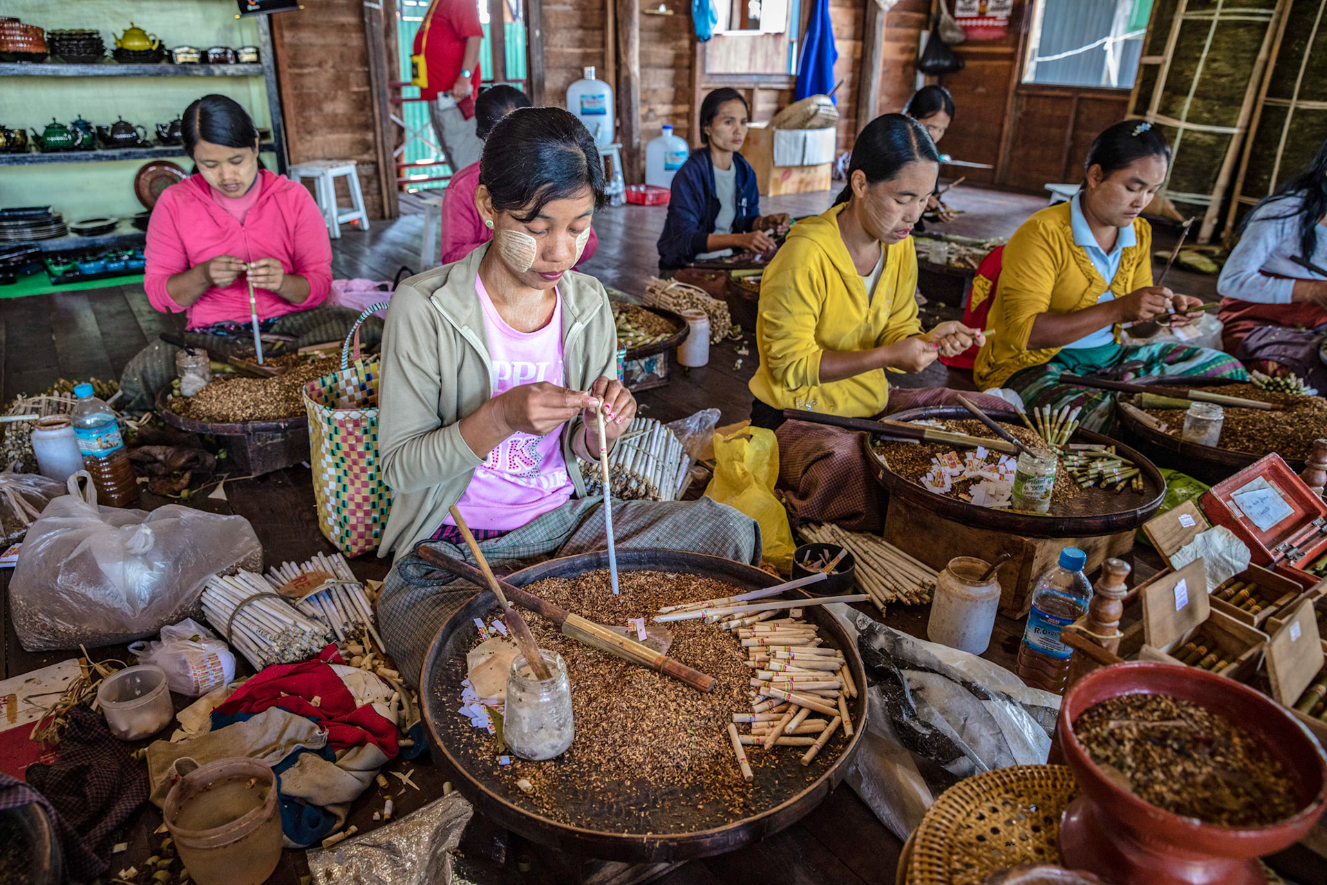 Burmese women making cigarettes and cigars on Inle Lake, Myanmar.