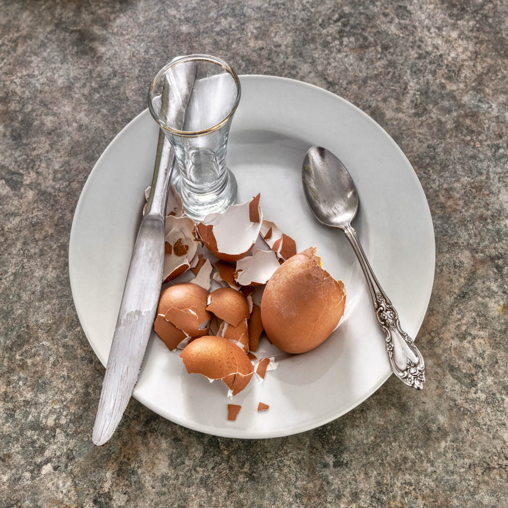 overhead photo of a breakfast plate with broken eggshells