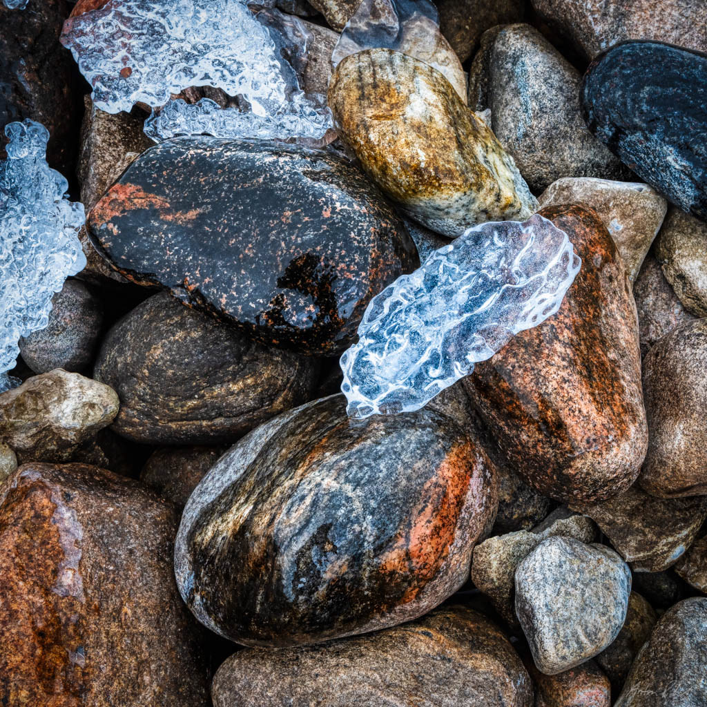 close up photo of a shard of ice on rocks
