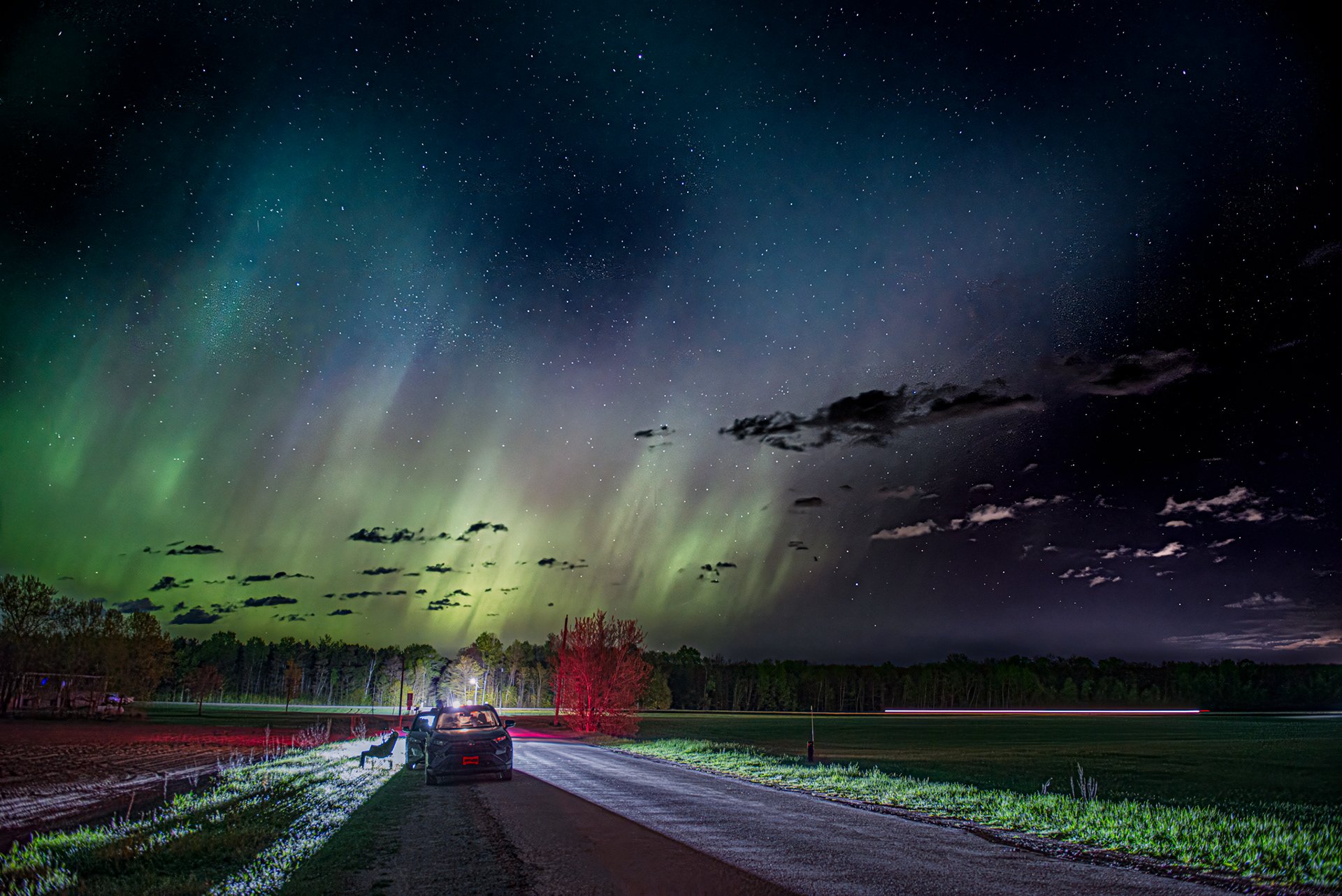 image of aurora with car in the foreground backlit