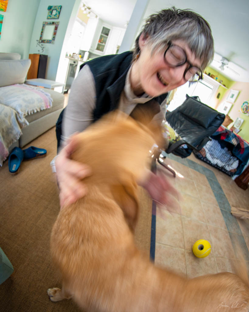 bllurred photo of a woman playing with a dog
