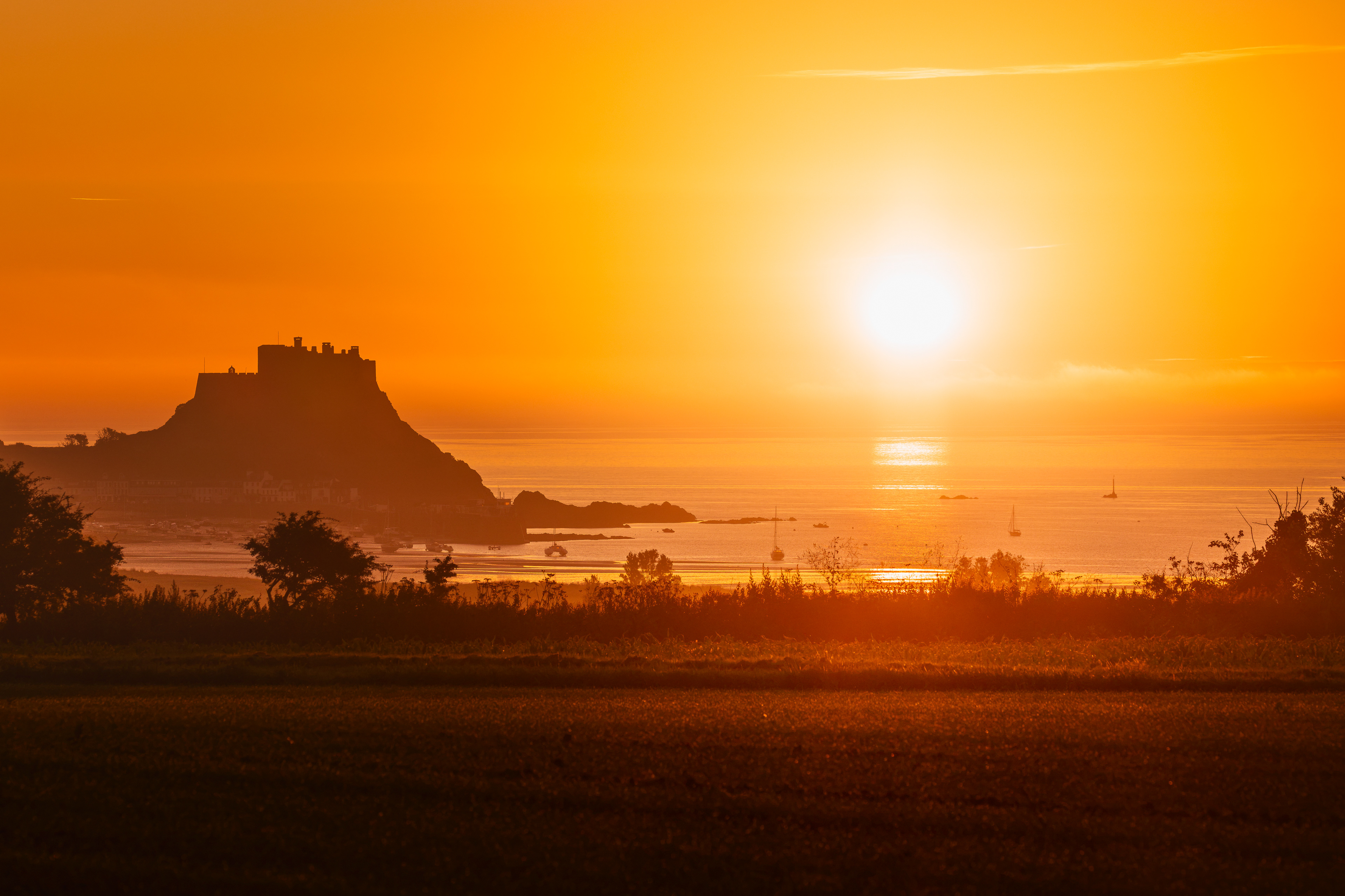 Mont Orgueil, rising golden solstice sun