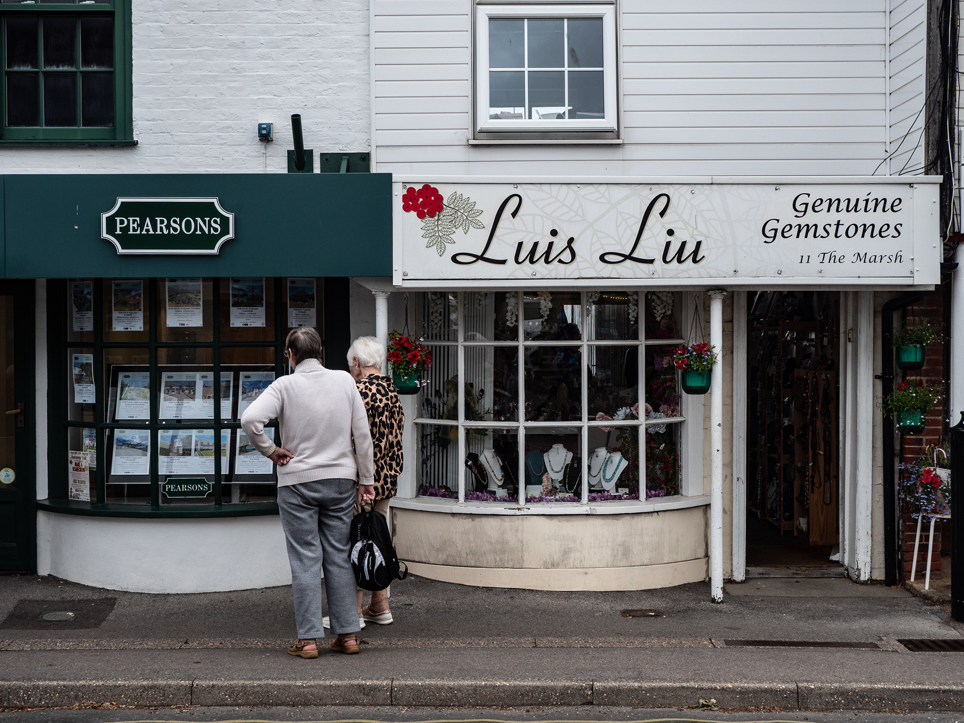Couple looking in estate agent window, Hythe