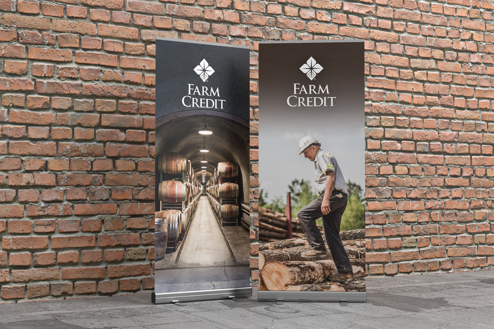 Two pop-up display banners sitting against a brick wall