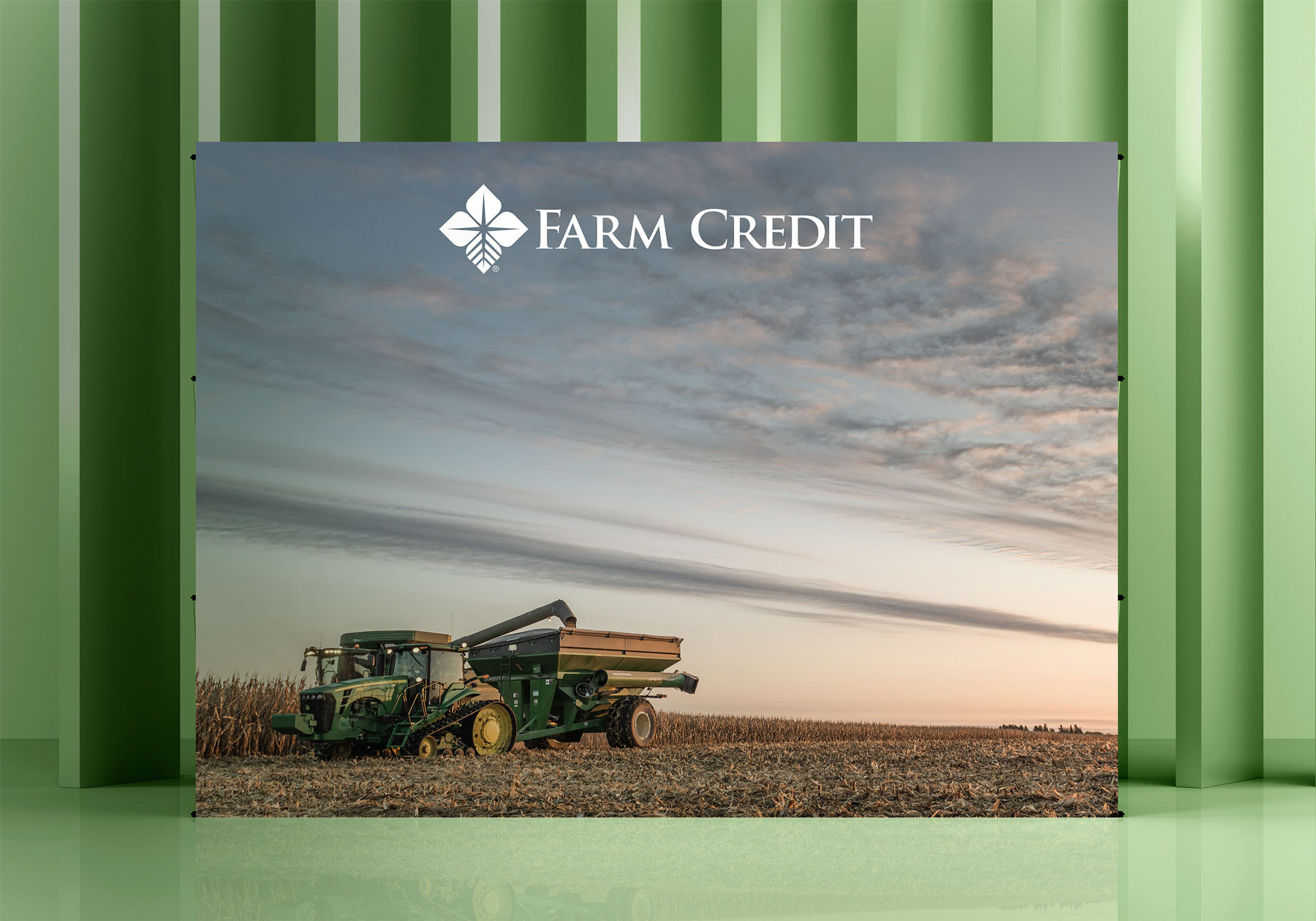 Expandable wall banner of a truck in a corn field with the Farm Credit logo