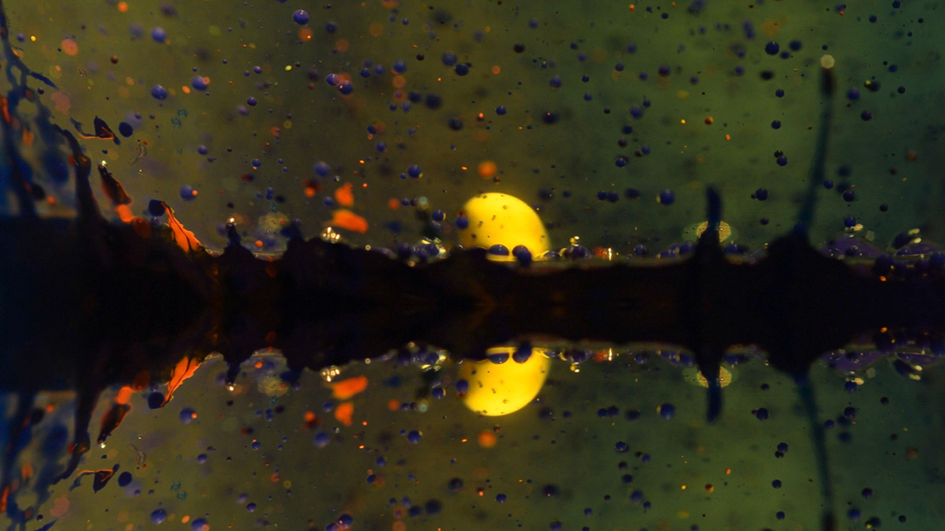 Different colored materials reacting into a oil infusion. Print screen