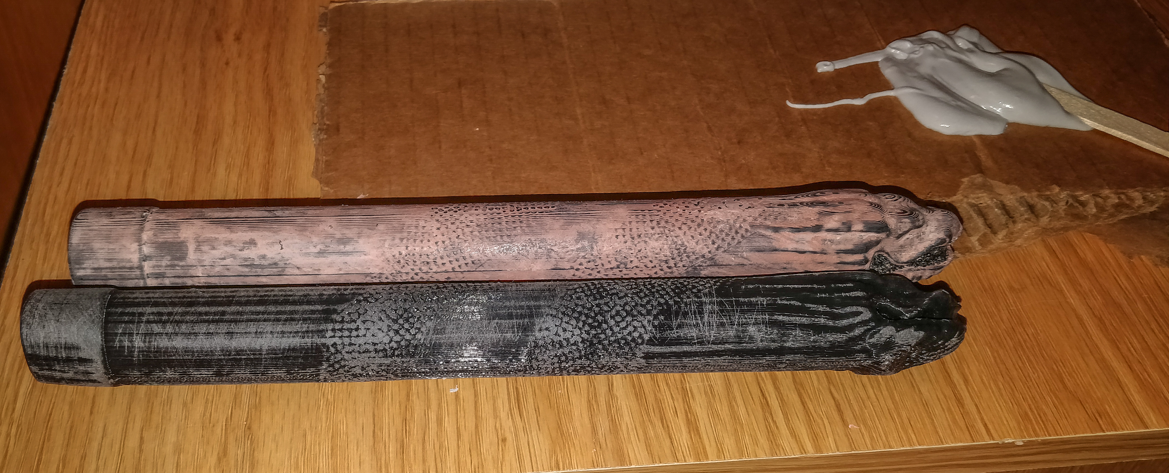 One sanded nunchuck next to a Bondo-ed and sanded one.