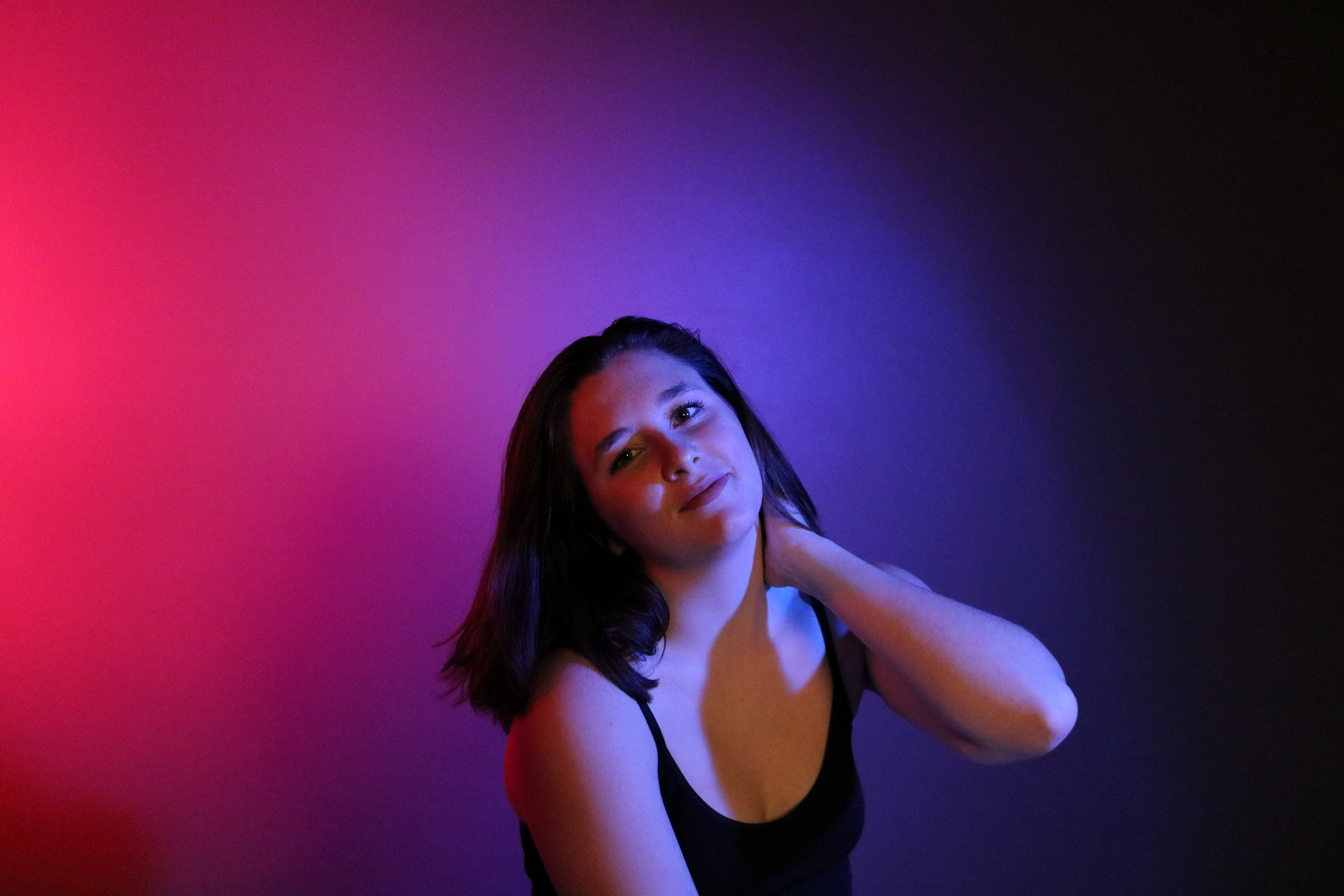 Portrait of Sloan, taken in the photo studio. I used three-point lighting, with blue and red gels over softbox lights to create a soft, multi-colored image. I used another softbox light on a dim setting as the key light to illuminate her features without color, but still keep the soft light I wanted.