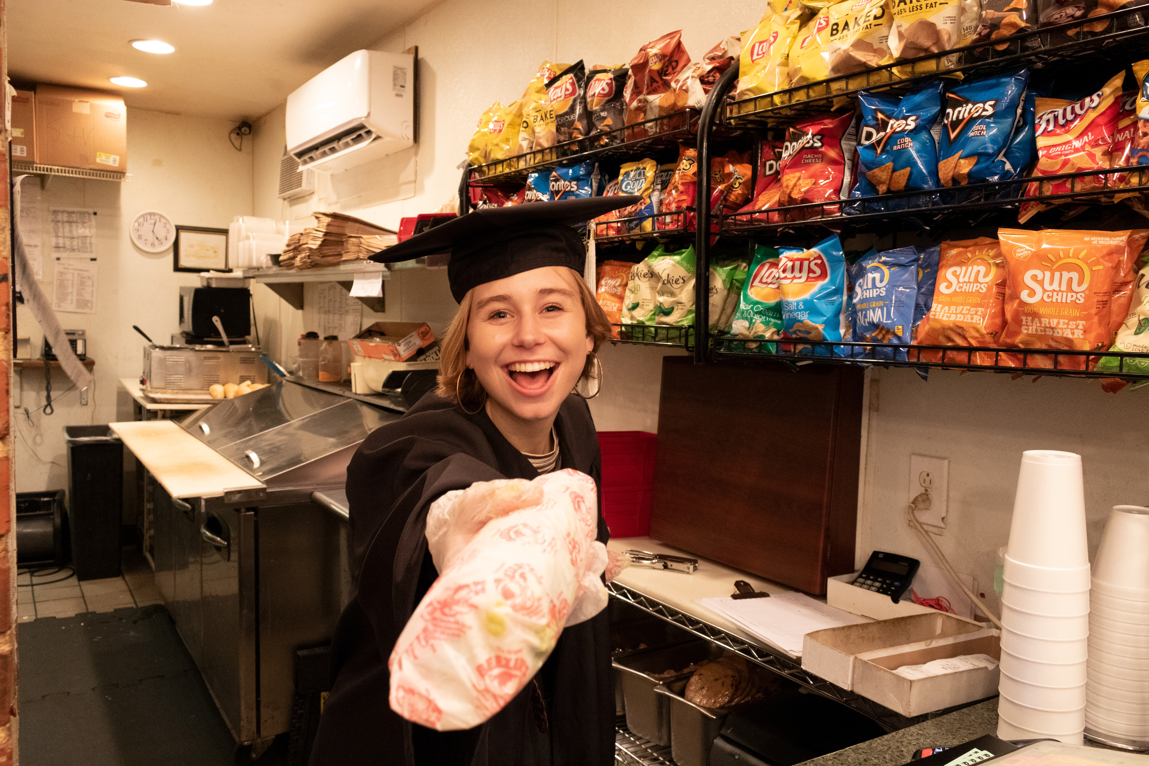 Recent graduate Grace makes and serves a sandwich at local restaurant Beezer’s, a favorite stop for UofSC students. This shoot was very fun, as I wanted to capture her in her workplace that defined her college years (1/2).