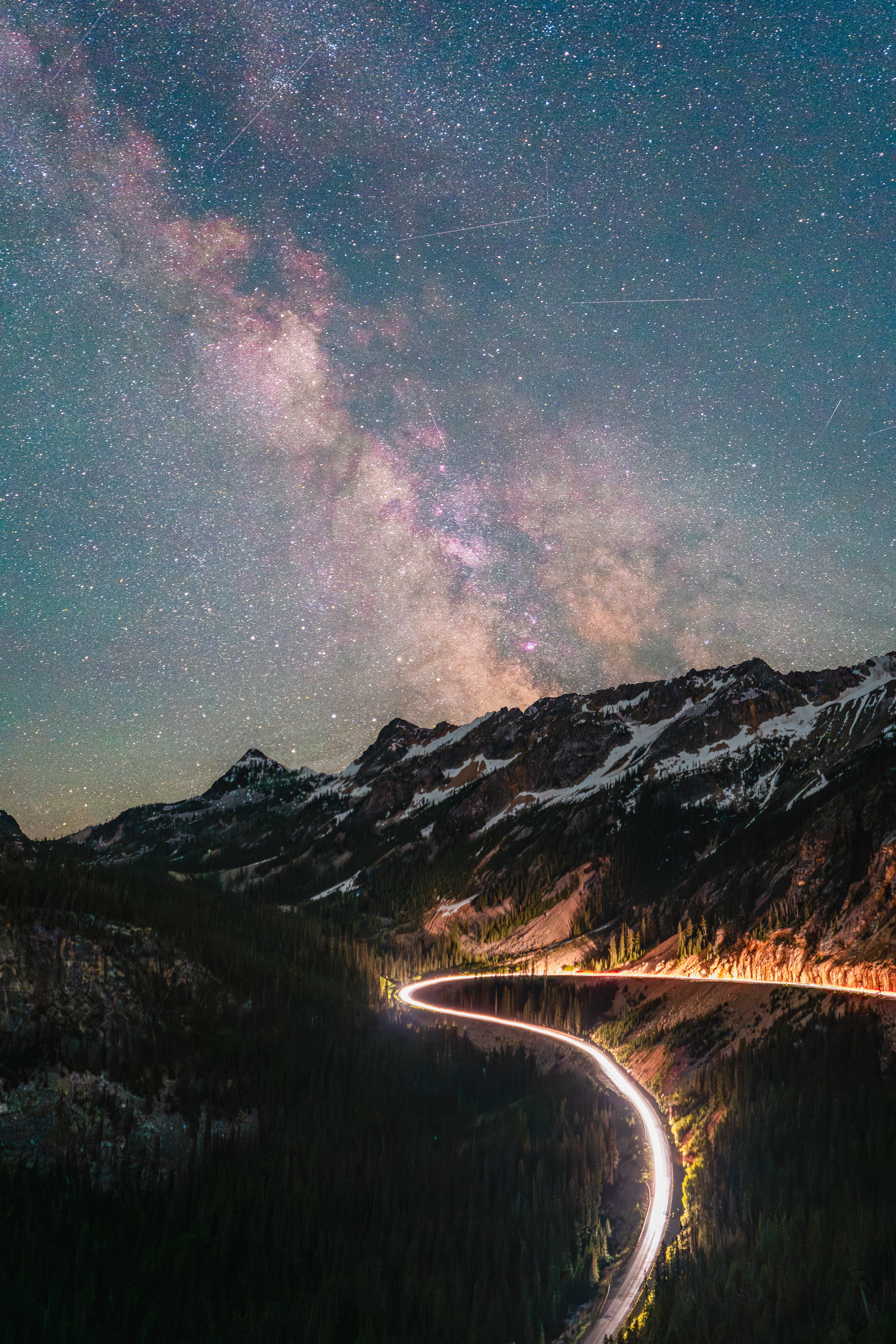 Cars pass under the milky way at Washington Pass