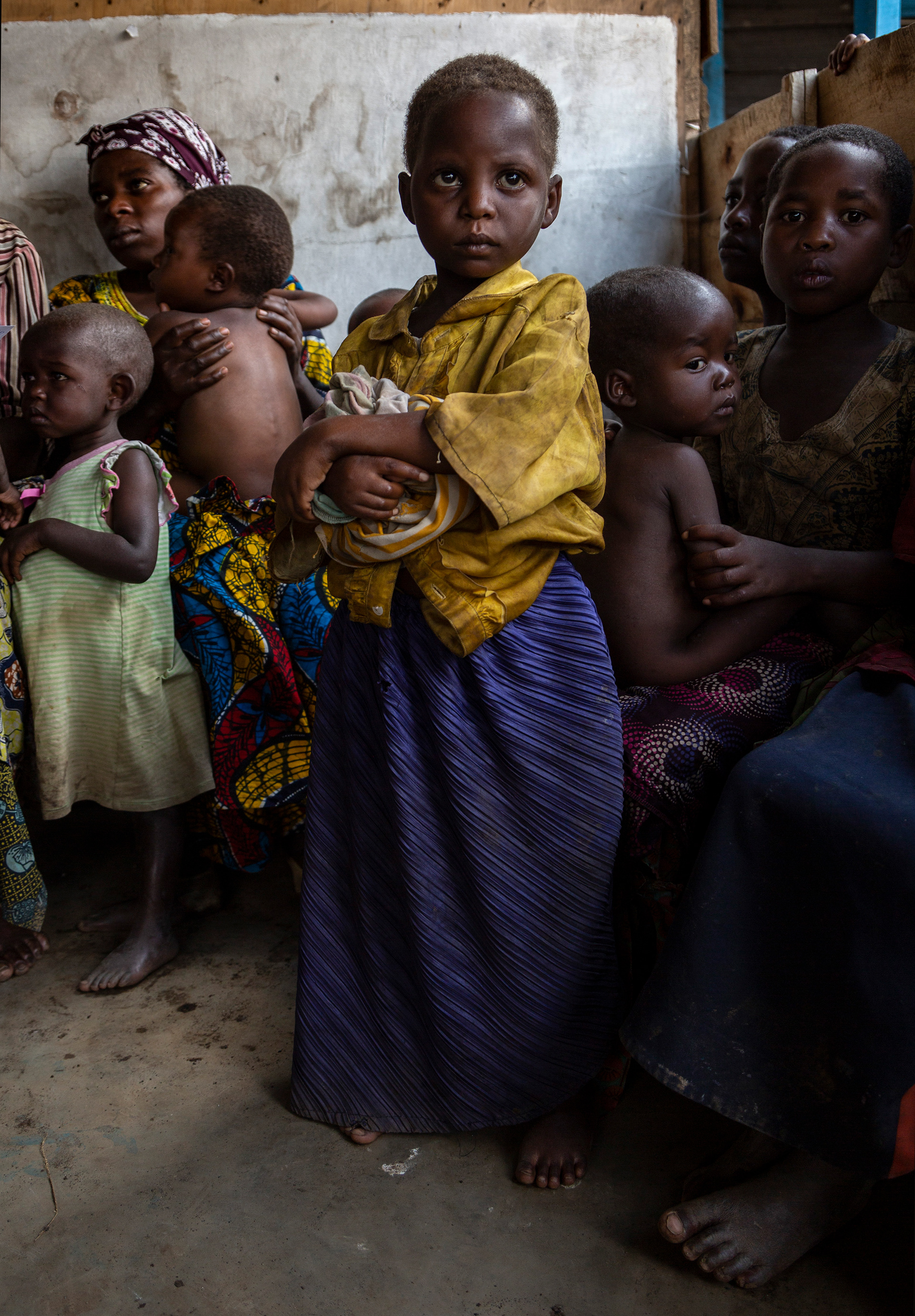 5 year old Sifa Havugimana waits for her turn to be monitored for malnutrition. 
