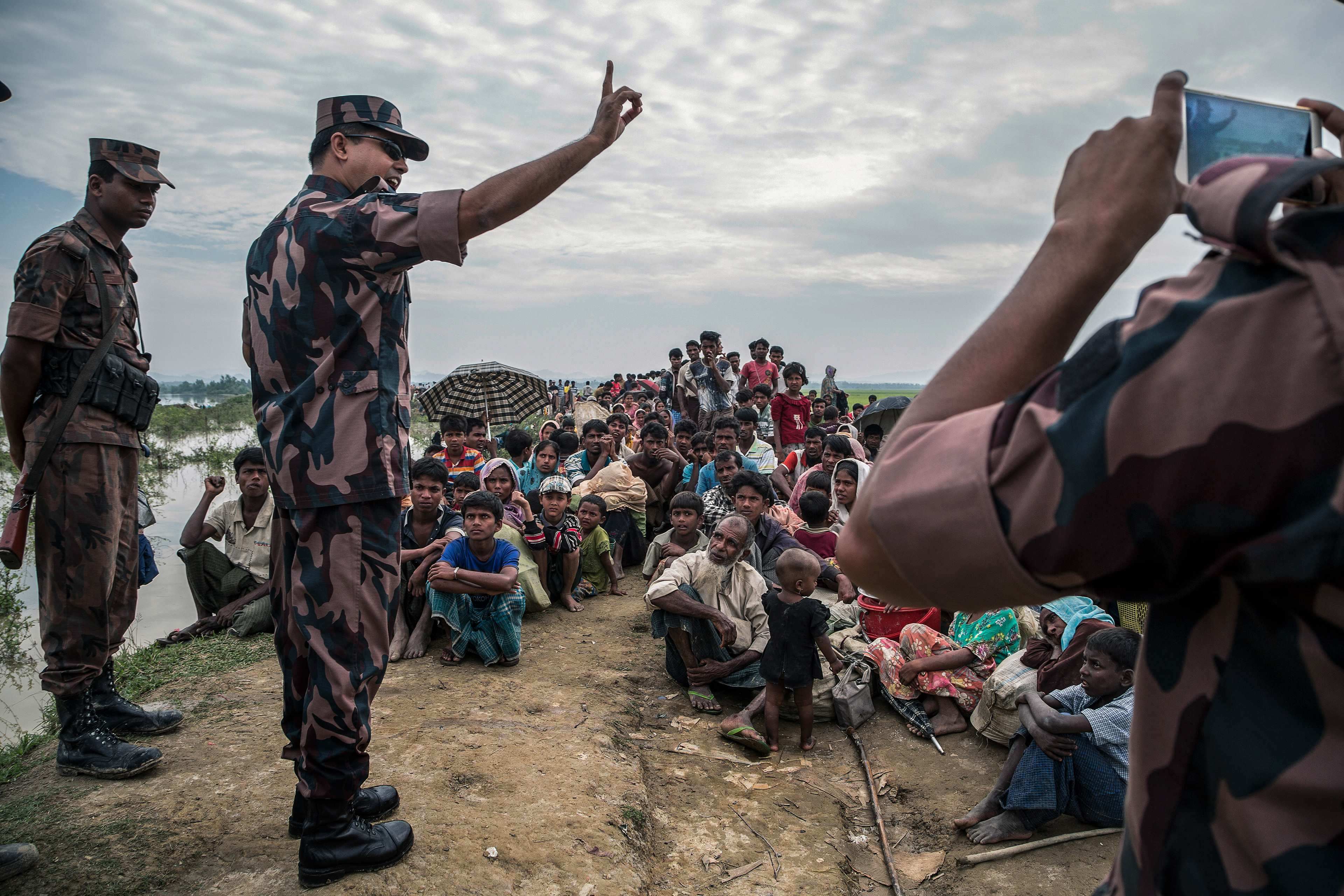 Bangladeshi border guards advising the refugees