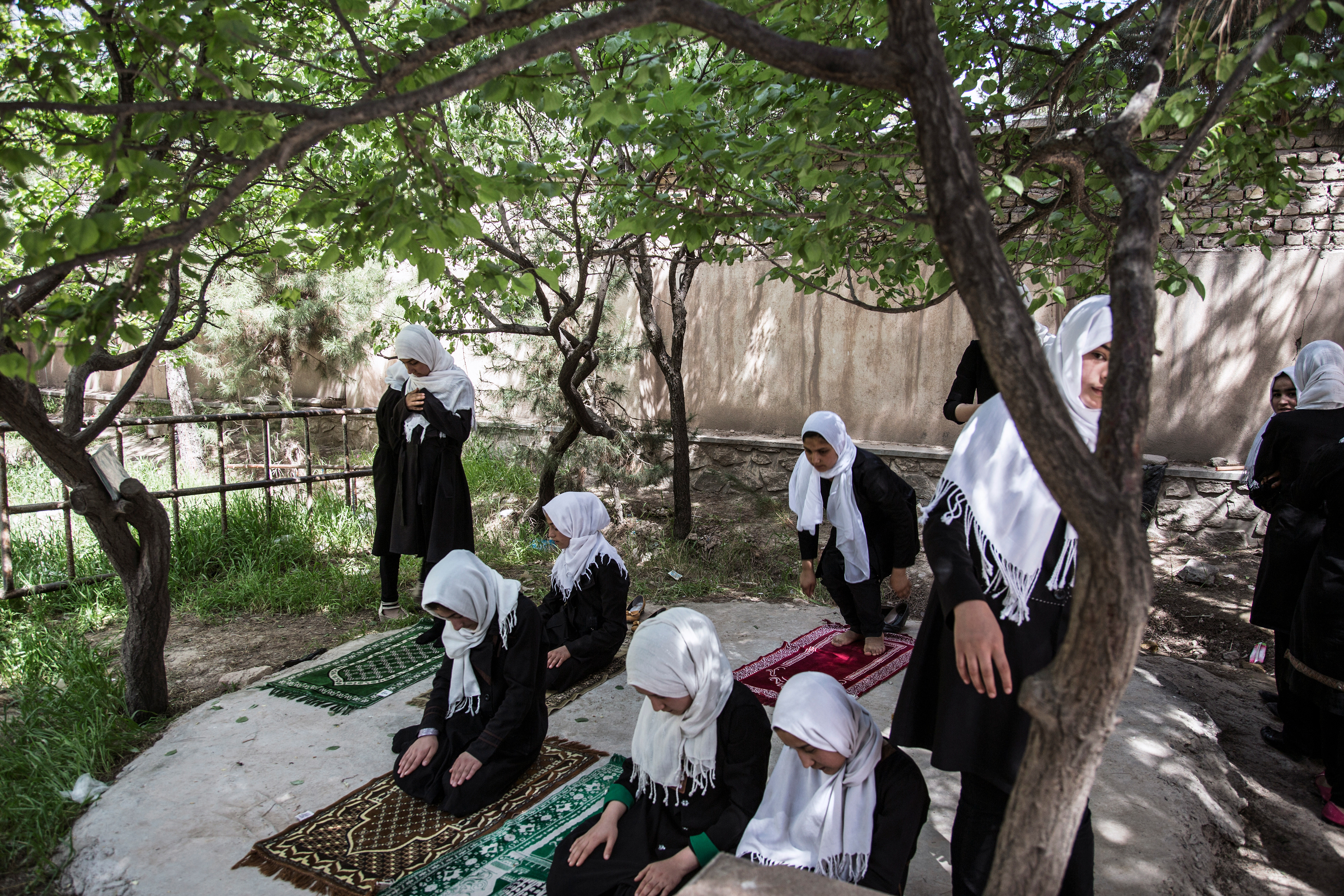 Schoolgirls praying,  Jalalabad, 2016