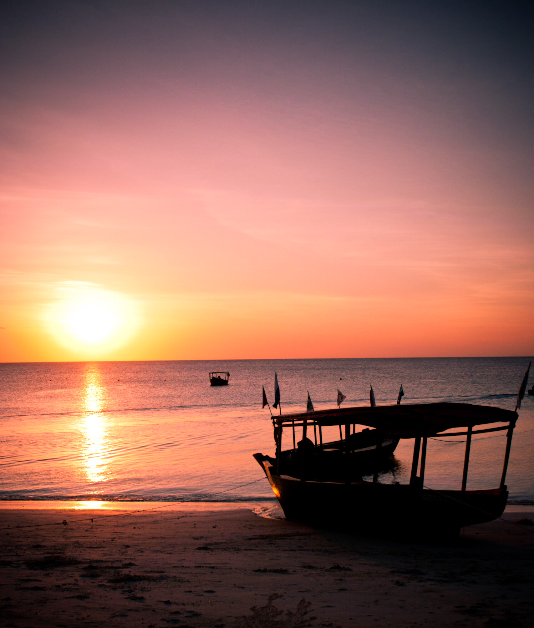 The sunsets as the tide is out in affect beaching the local snorkeling boat on the northern tip of Zanzibar Island.