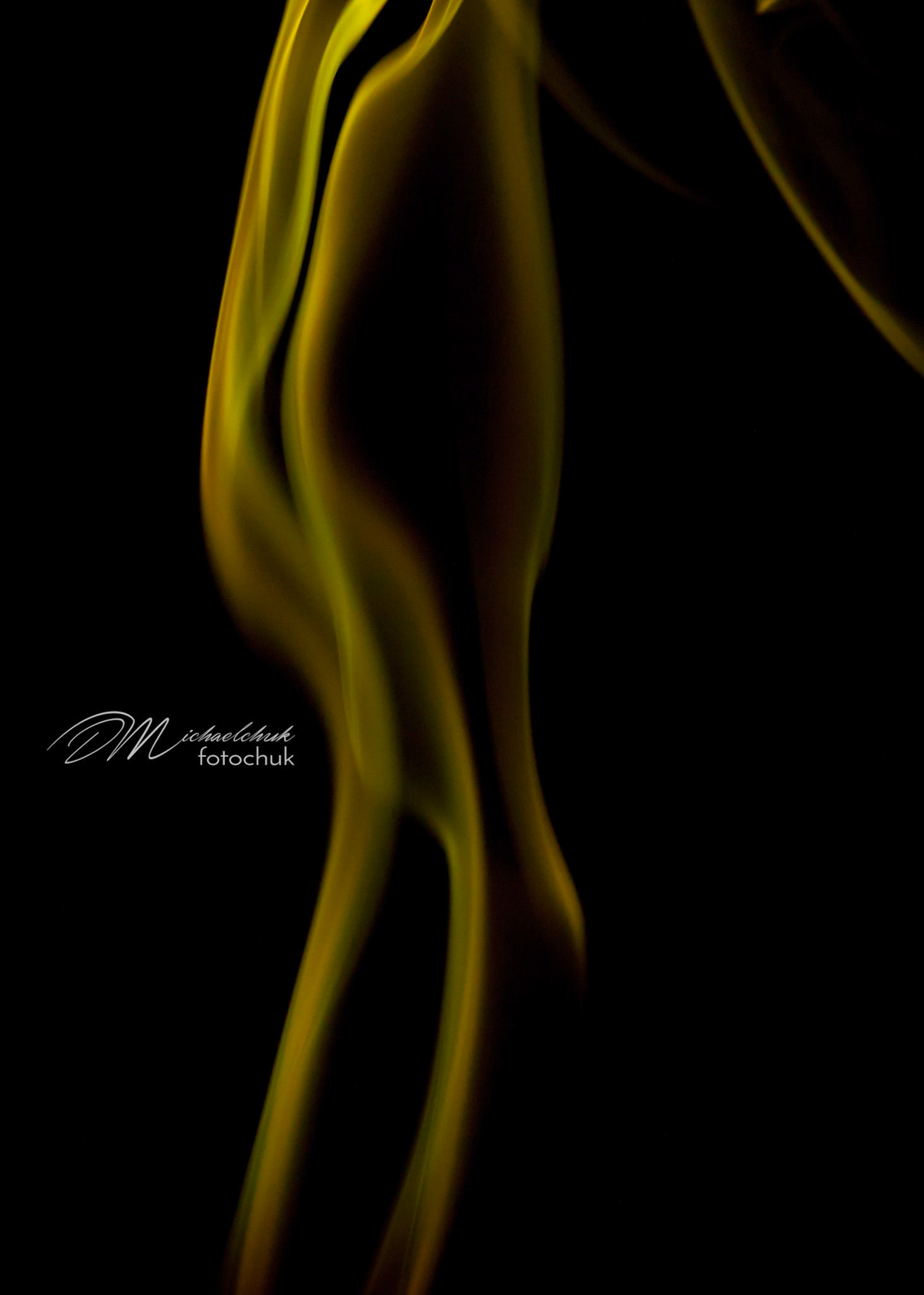 Smoke from burning incense showcased in yellow light.