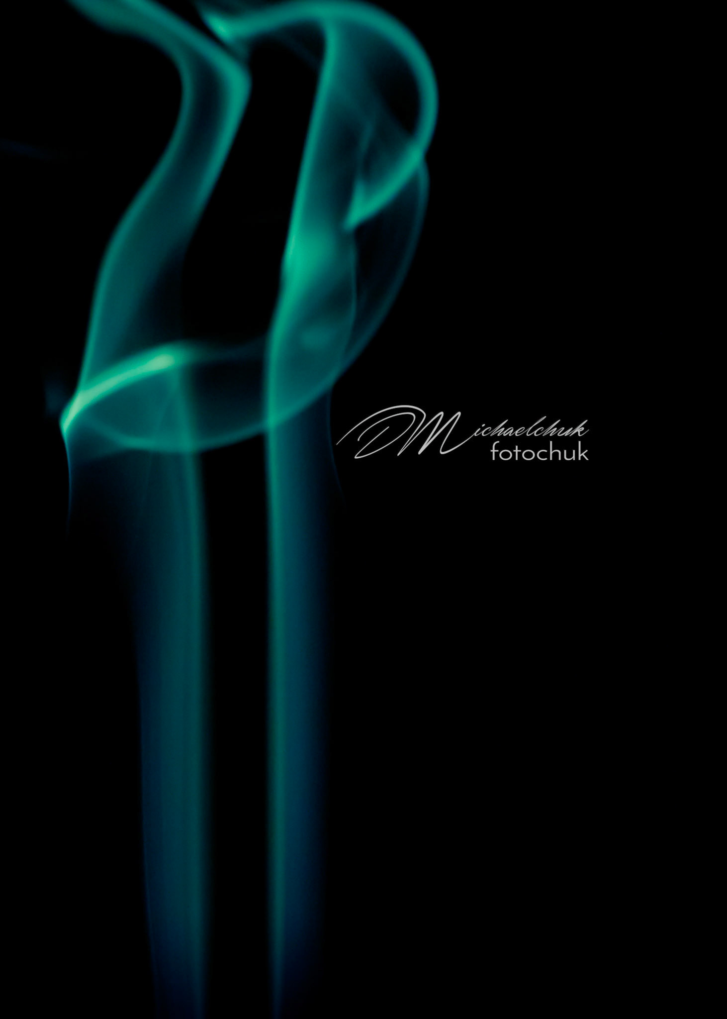 Smoke from burning incense showcased in light blue light.
