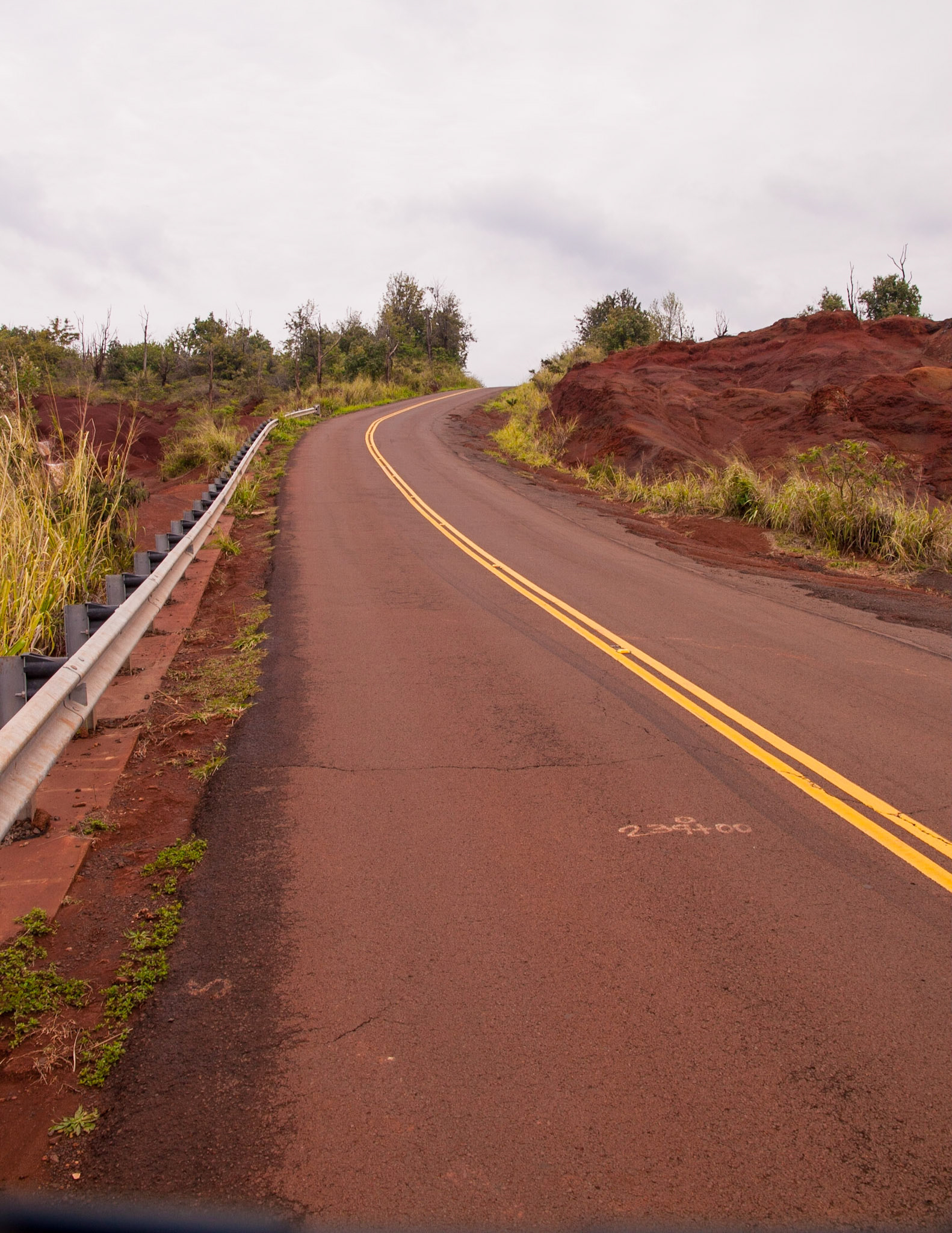 This is the narrow, winding road up and over the center of the island of Kauai with is unique red volcanic dirt on both sides.