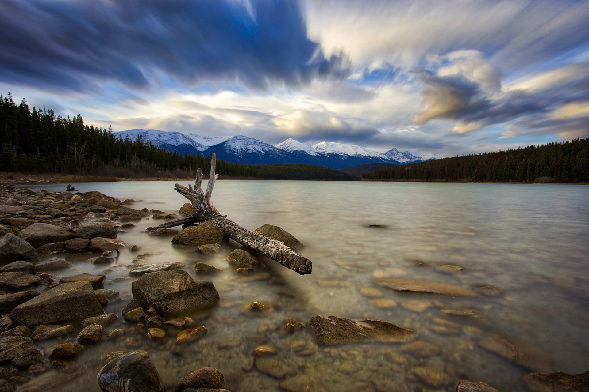 A lon exposure shot as the sun rises on Patricia Lake in Jasper.