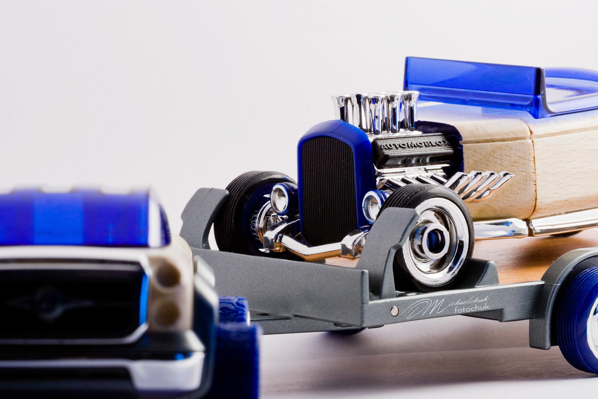 This was my first shoot with a real macro lens.  It was inspired and composed for the “from every angle” monthly project at photoblogchallenges.com.  The subject in this series, Automoblox truck and hot rod , has got to be one of the coolest toys ever.  I would almost have to say its right up there with Lego.  My son will play with just these two vehicles for hours.The shoot itself was very interesting.  I had a real challenge getting the lighting and background just right.  Over the course of an evening, I ended up building my own light box out of a beer case, white paper and scotch tape and a 2000watt halogen.  It worked surprisingly well.