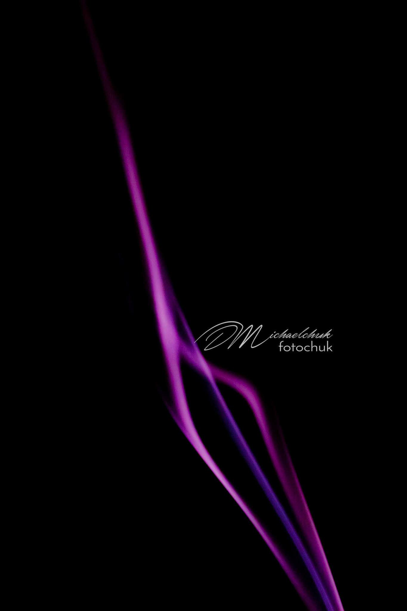 Smoke from burning incense showcased in purple light.