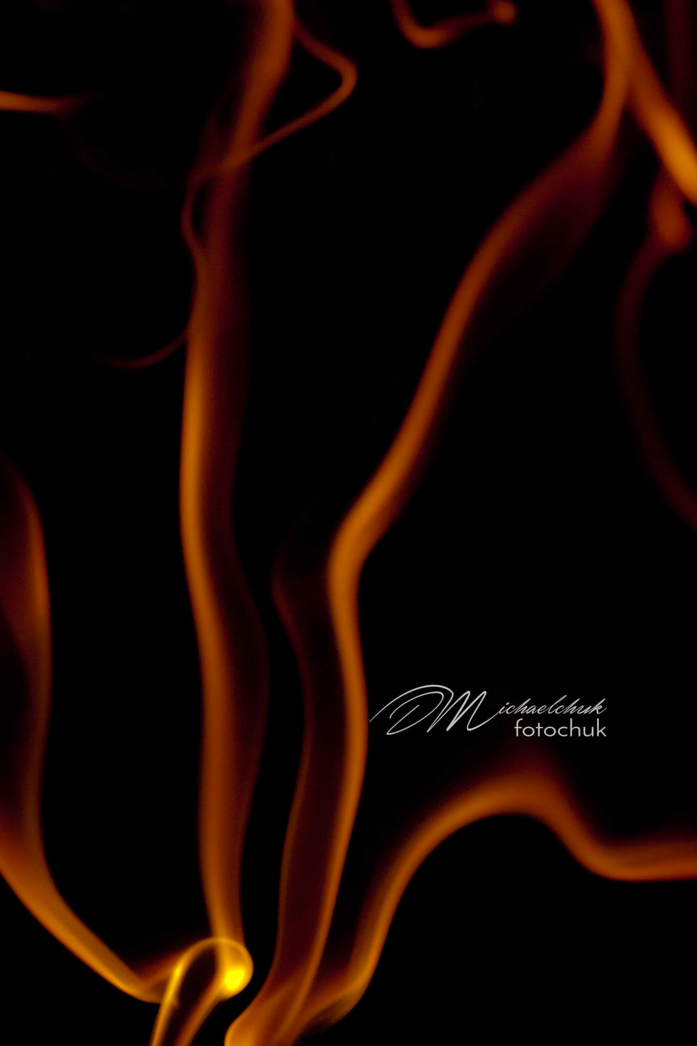 Smoke from burning incense showcased in orange light.