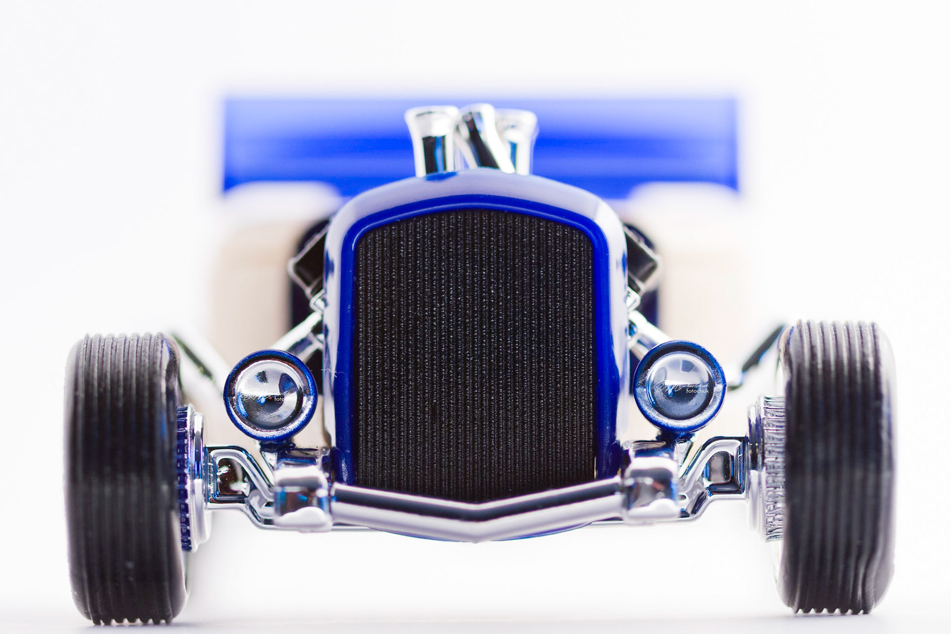 This was my first shoot with a real macro lens.  It was inspired and composed for the “from every angle” monthly project at photoblogchallenges.com.  The subject in this series, Automoblox truck and hot rod , has got to be one of the coolest toys ever.  I would almost have to say its right up there with Lego.  My son will play with just these two vehicles for hours.The shoot itself was very interesting.  I had a real challenge getting the lighting and background just right.  Over the course of an evening, I ended up building my own light box out of a beer case, white paper and scotch tape and a 2000watt halogen.  It worked surprisingly well.