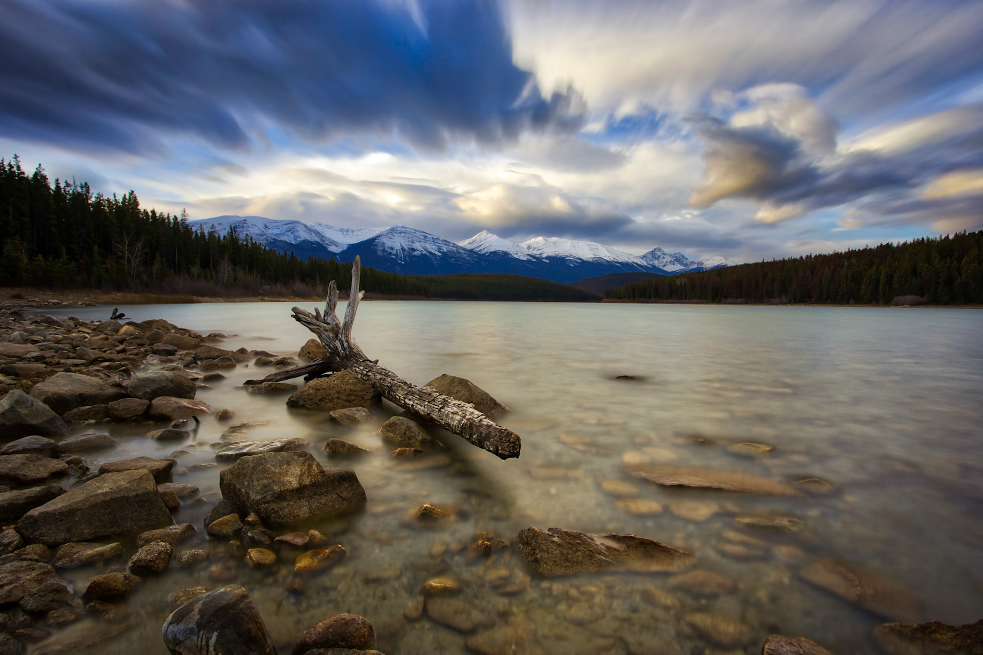 A lon exposure shot as the sun rises on Patricia Lake in Jasper.