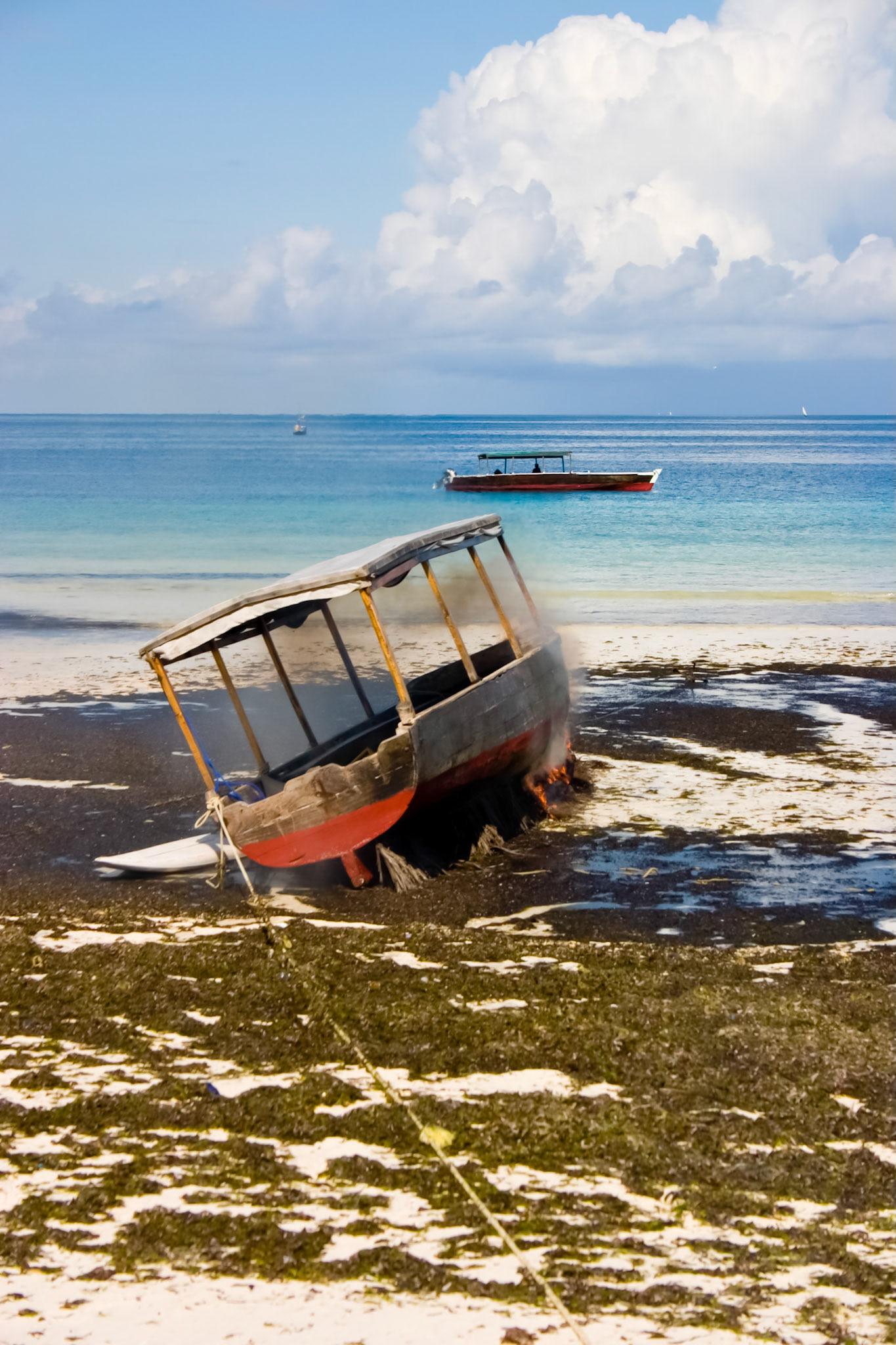 I am not exactly sure what the process is here.  But they were carefully burning the hull of this boat as a form of maintenance.