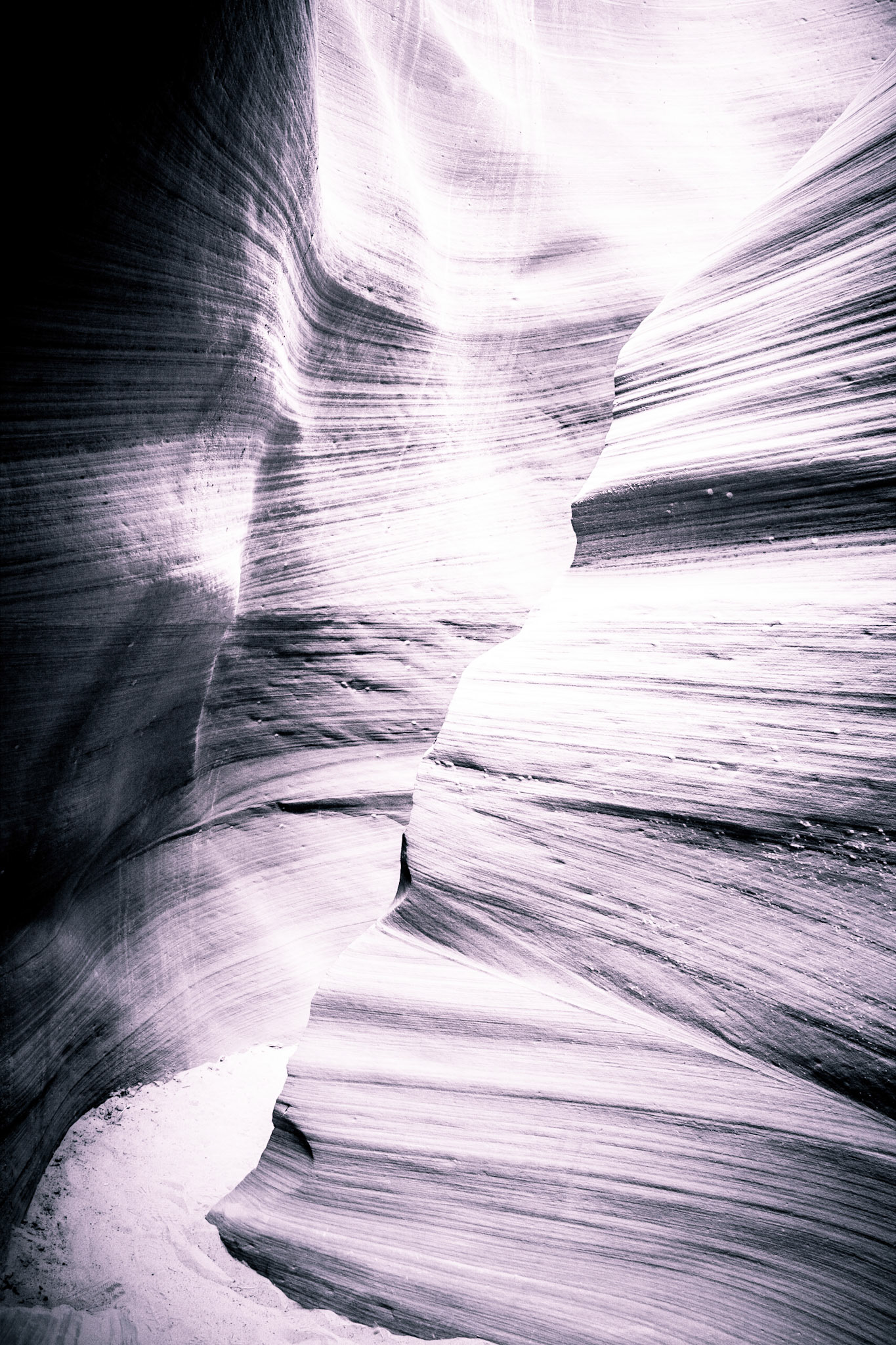 Processed with a subtle cyan split tone, the lines in the walls Lower Antelope Canyon take on a new life.