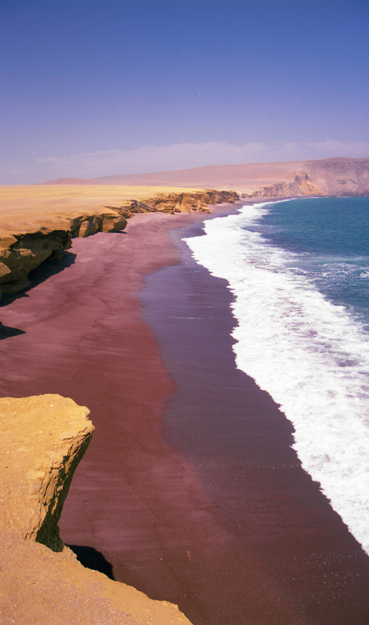 This awesome red sand beach is between bone dry desert and the ocean in Peru.