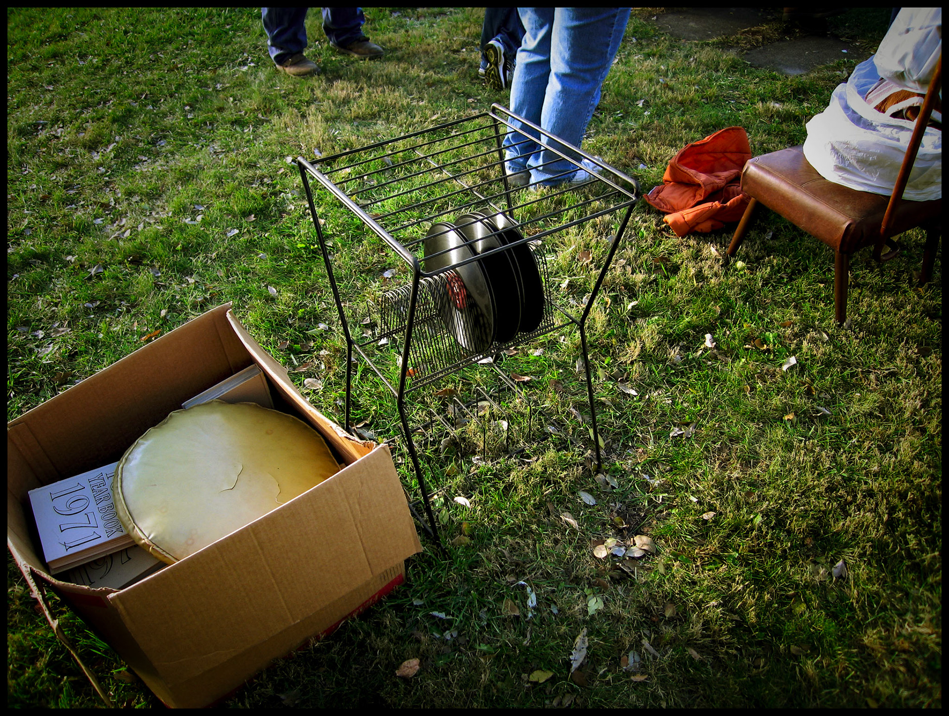A stand of old 78rpm records and a box of yearbooks at an auction. Green City, Missouri USA, 2006.