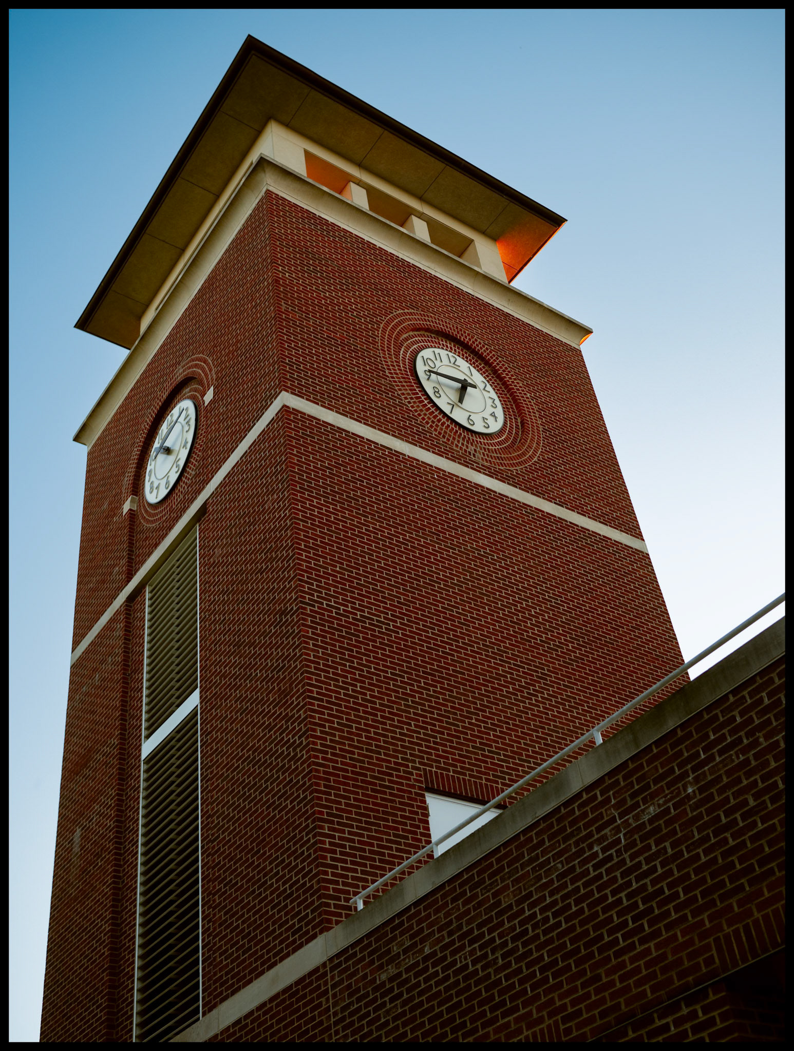 An upward view of the Truman State University Pickler Library Clock Tower backlit by the warm glow of the setting Autumn sun.. 2024