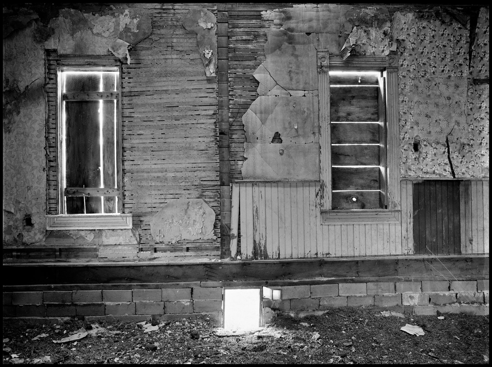 The interior of an abandoned house in an advanced state of decay. Near Pennville, Missouri USA, 1979.