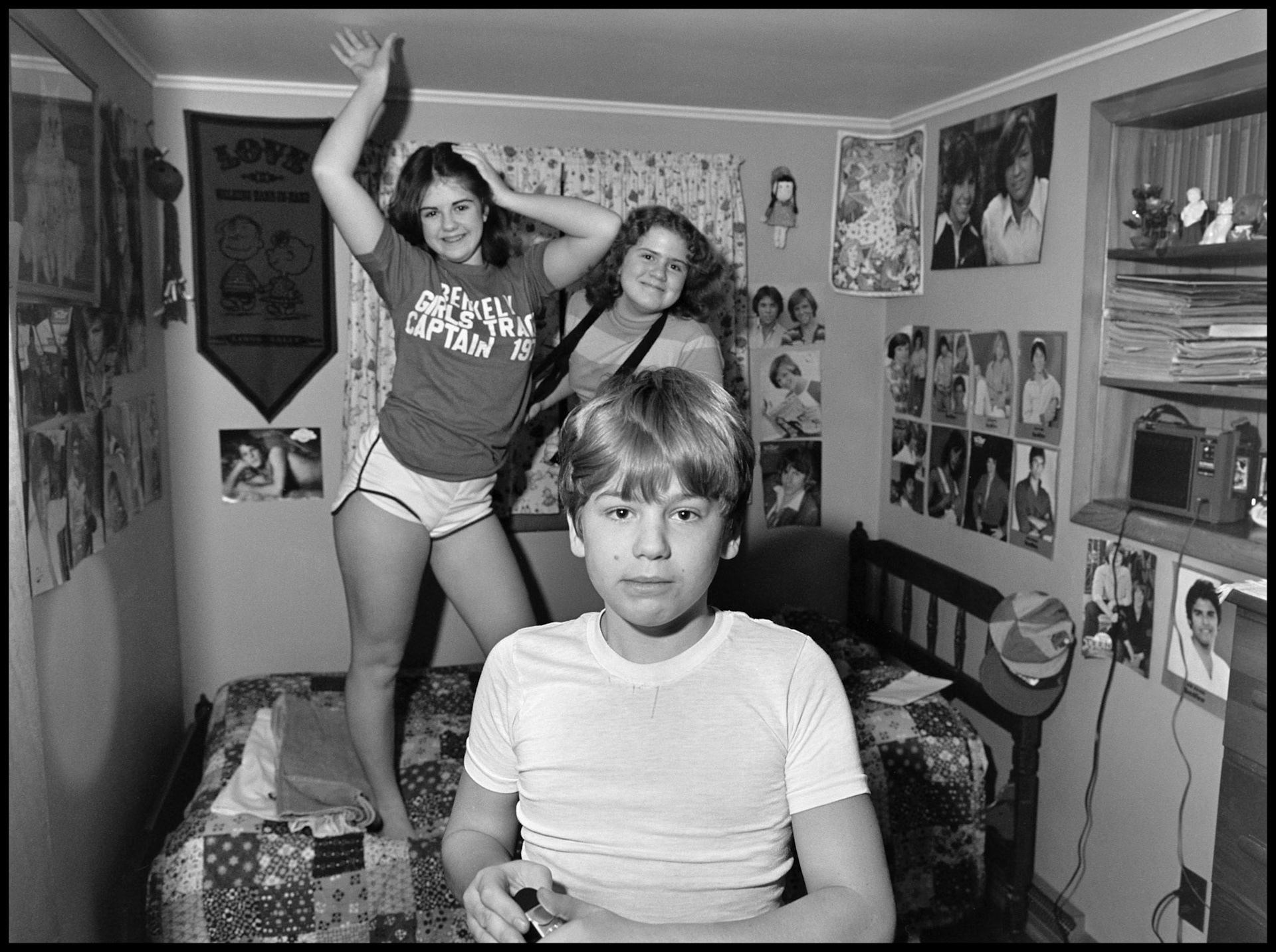 A 1970's vintage image of a boy feeling out of place in his teenage sister's bedroom. Kirksville, Missouri 1979