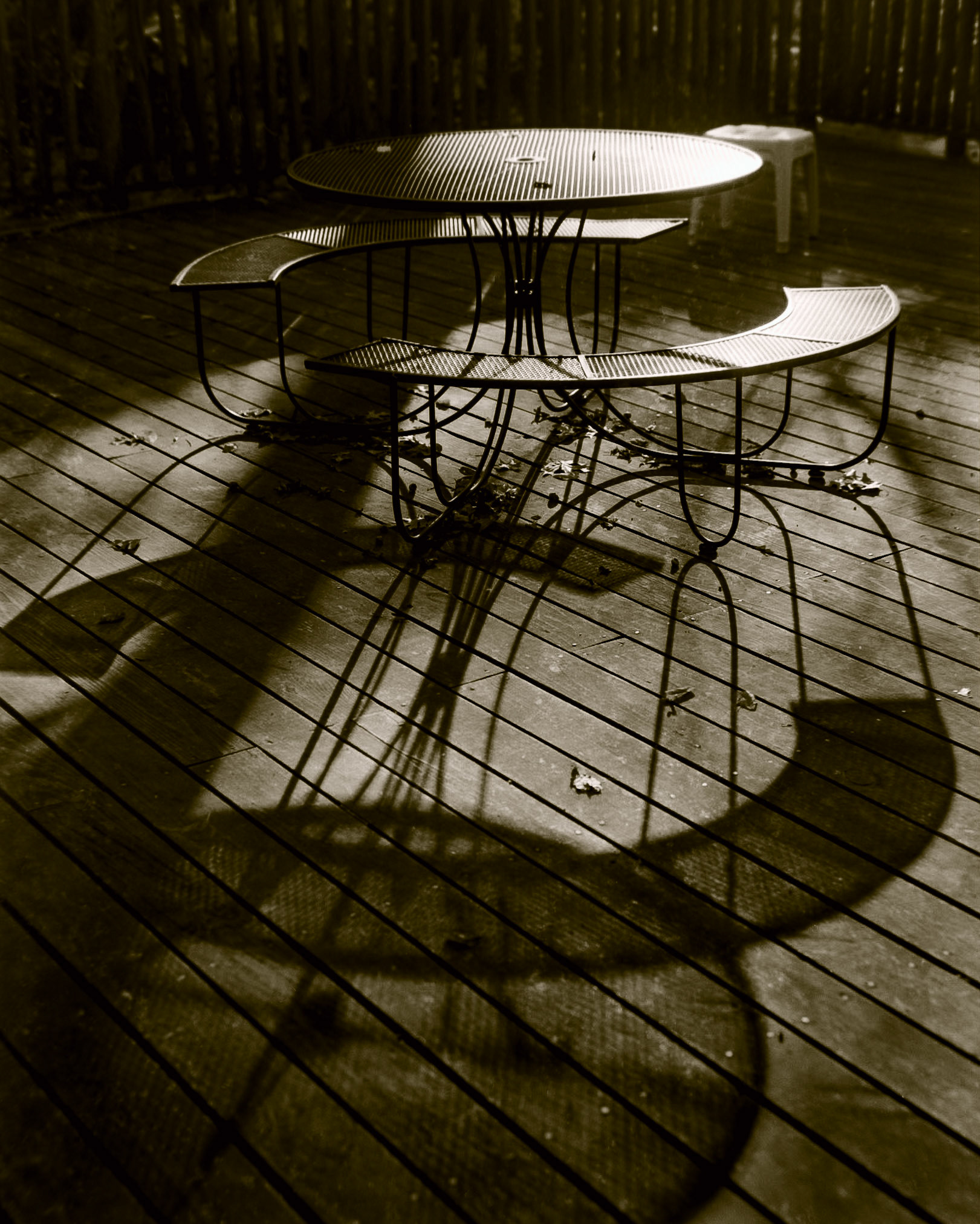 Patio Table backlit by the evening sun casting interesting shadows.