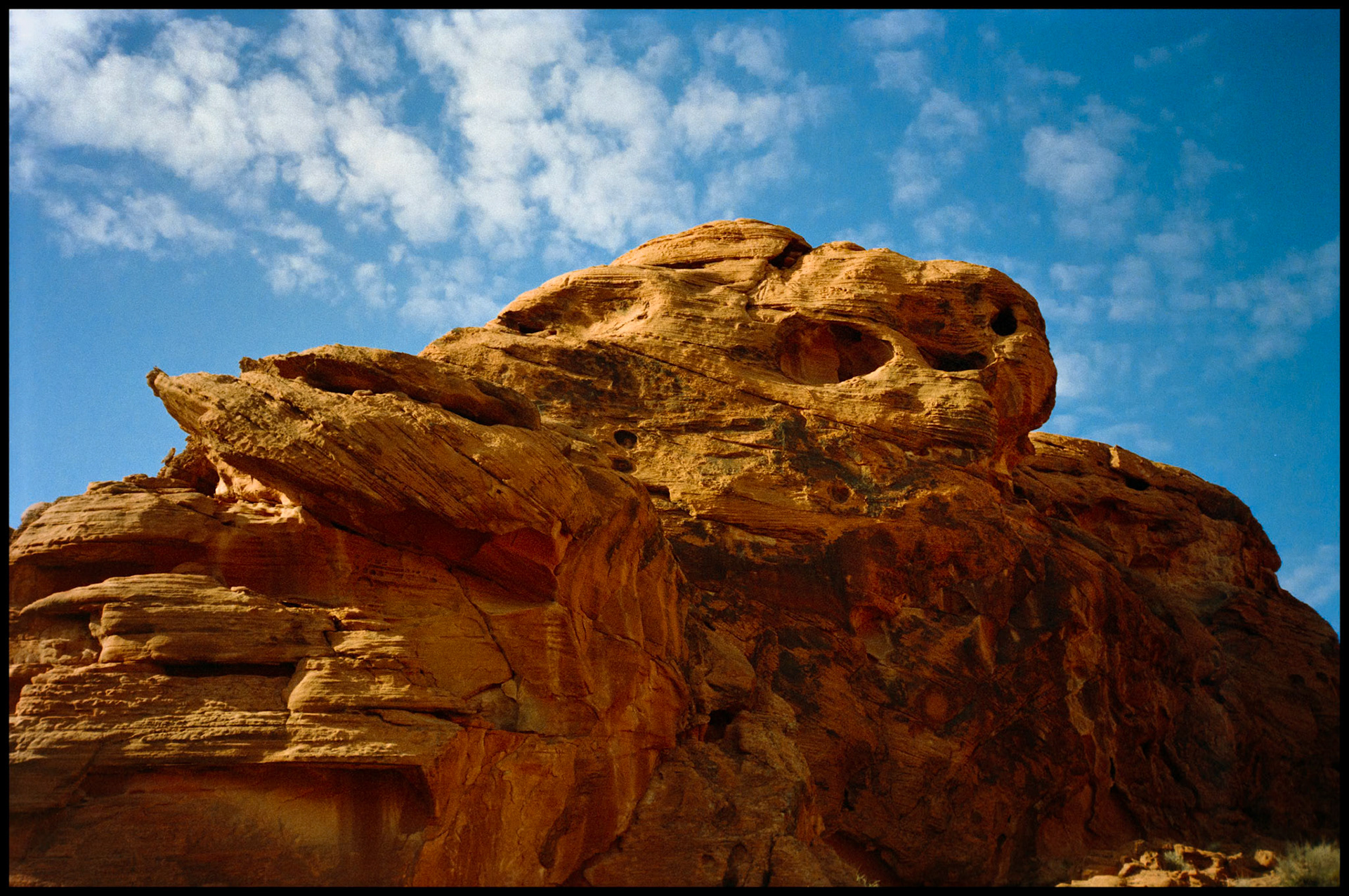 Red rock formations that have an anthropomorphic resemblence to heads of various kinds of goblins/aliens at Valley of Fire State Park near Moapa Valley, Nevada North of Las Vegas. 1992
