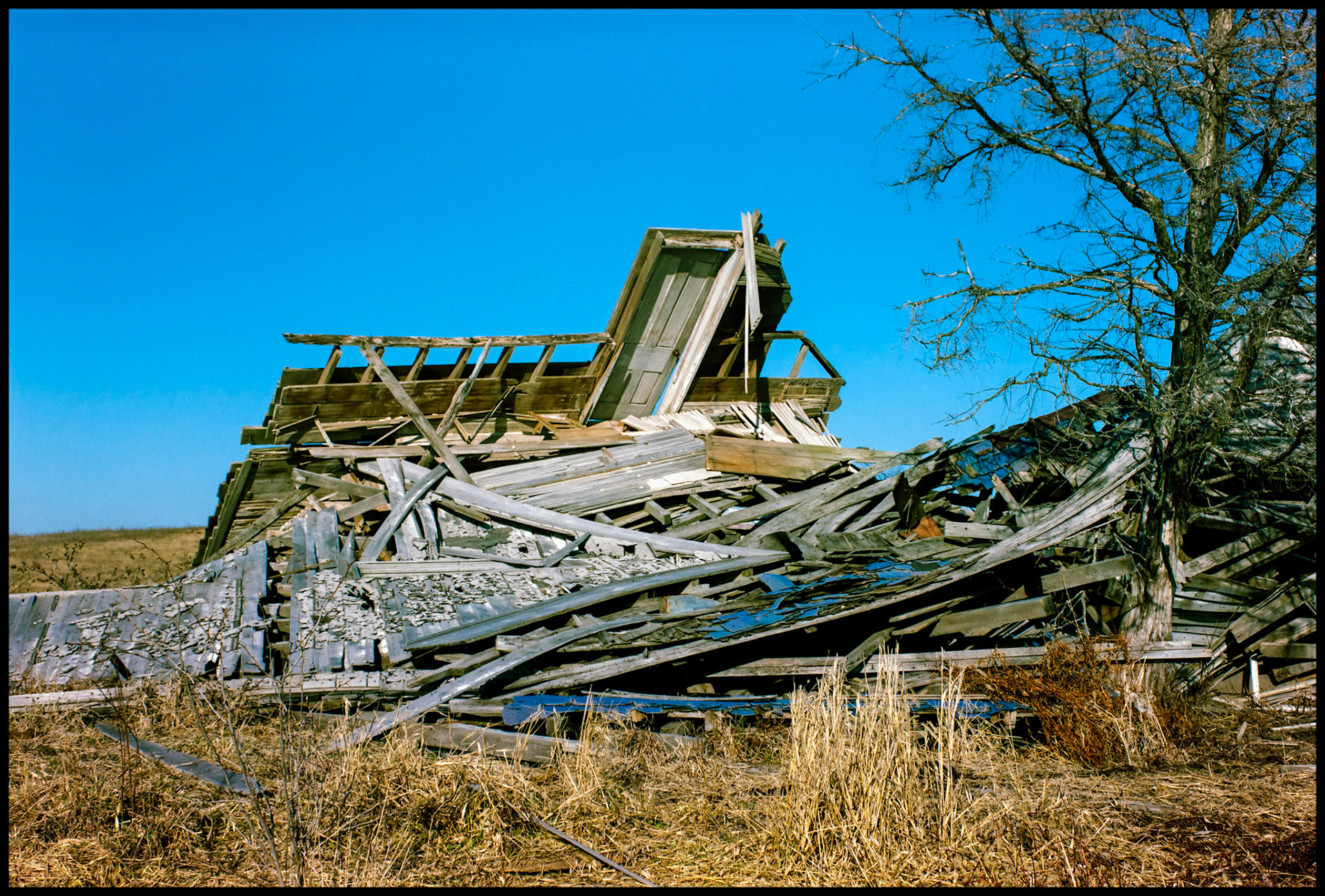 The only remaining door to an abandoned collapsed rural farmhouse. Near Green City, Missouri 1994