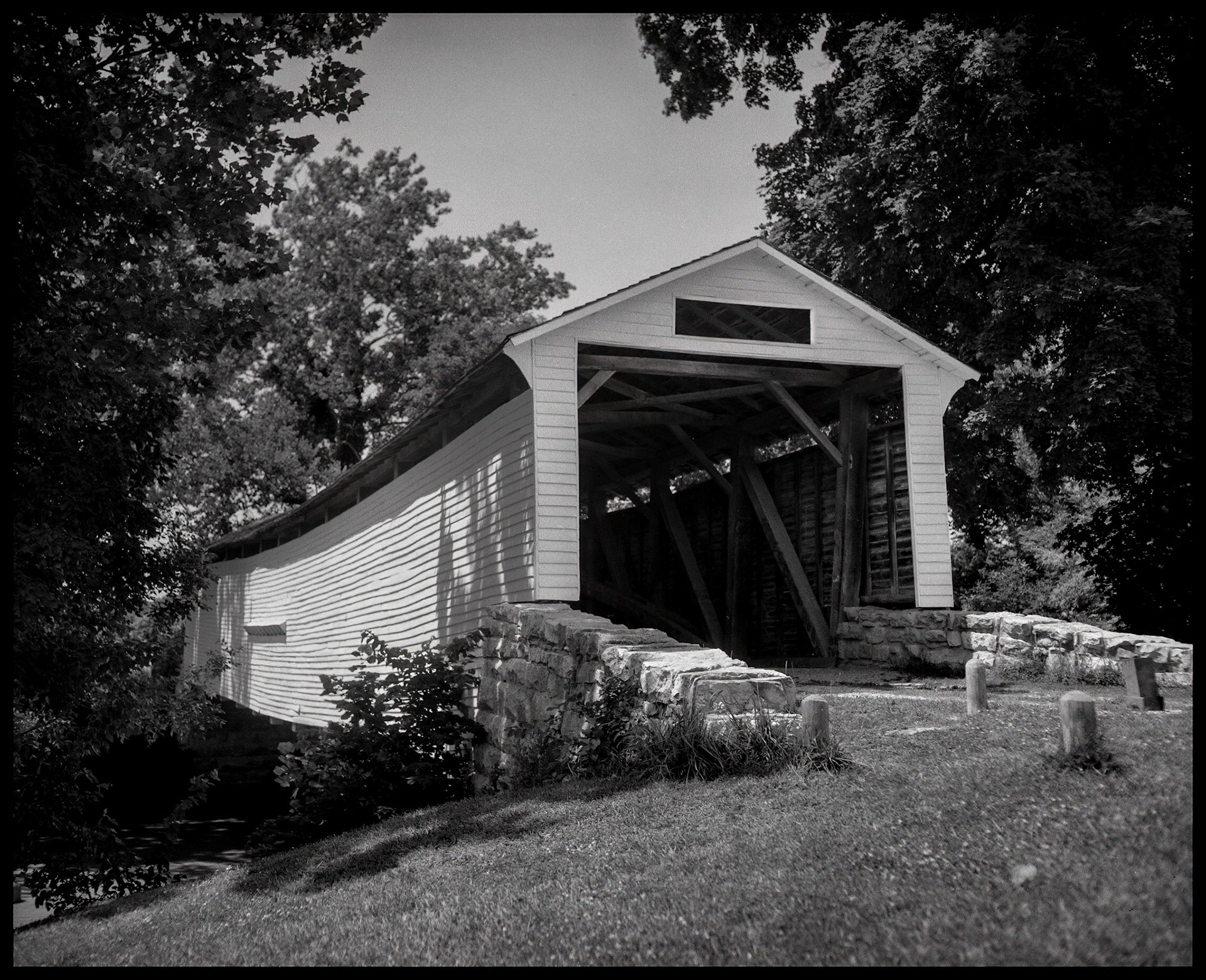 A 1984 vintage image of the Union Covered Bridge at the Union Covered Bridge State Historical Site near Paris, Missouri. The Union Covered Bridge, built in 1871, spans the Elk Fork of the Salt River in Monroe County Missouri and is the only one of the four remaining covered bridges in Missouri that represents the Burr-arch truss design. It served travelers in Monroe County for 99 years.
