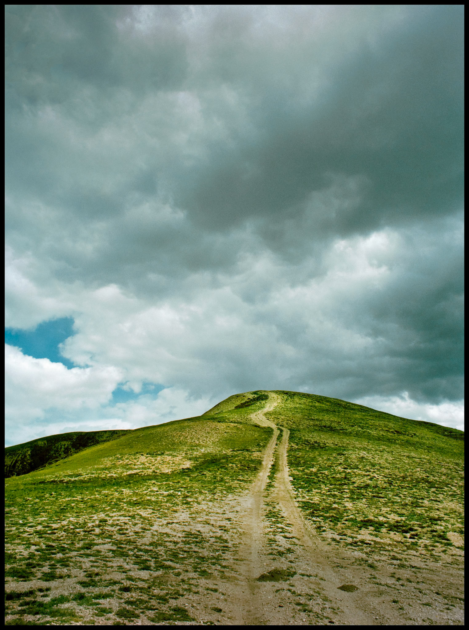 A very steep four wheel drive/ATV trail appearing to take you to the clouds at the summit of the mountain at Cumberland Pass between Tin Cup and Pitkin Colorado USA 1981