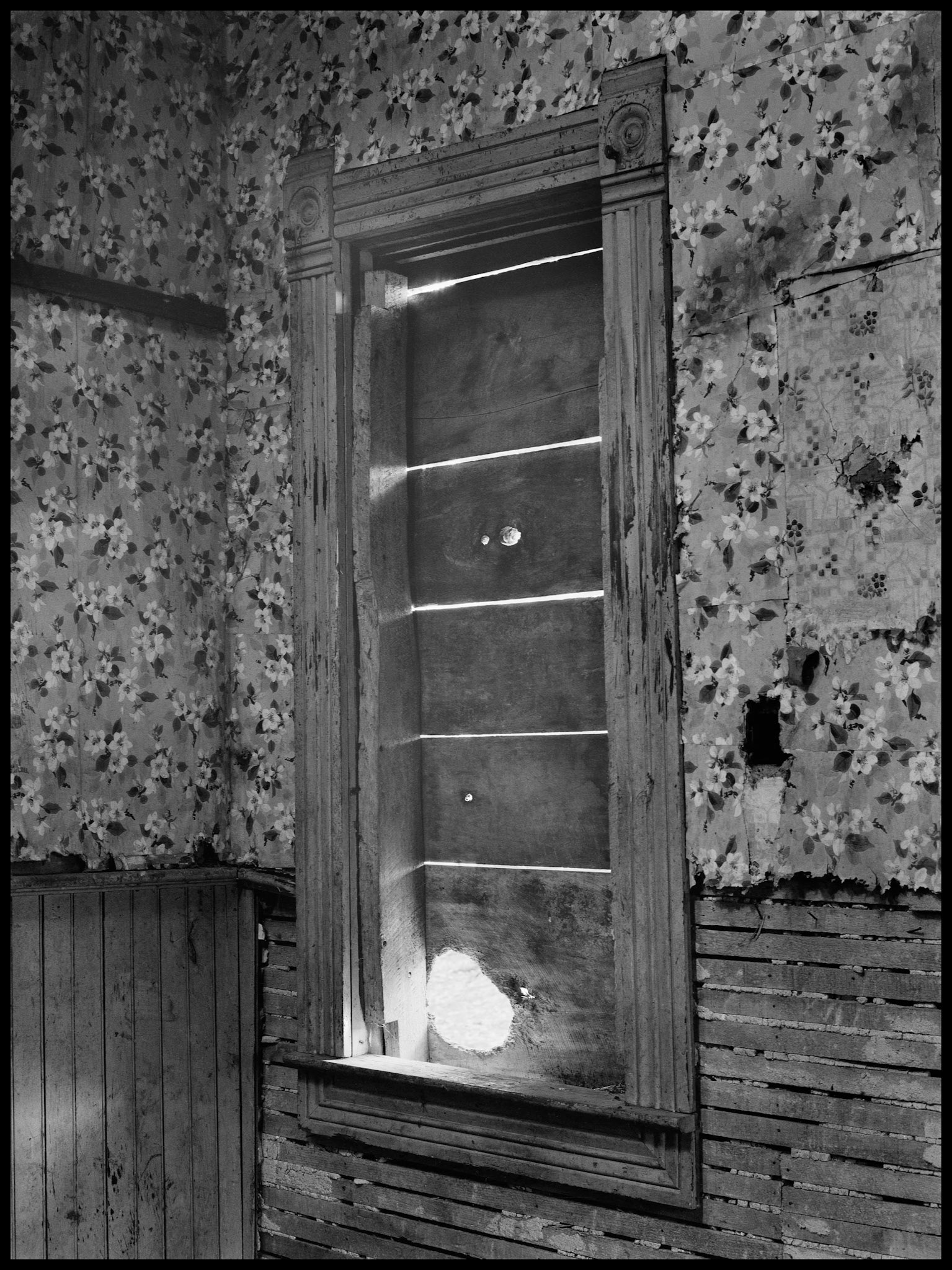 The interior of an abandoned house in an advanced state of decay. Near Pennville, Missouri USA, 1979.